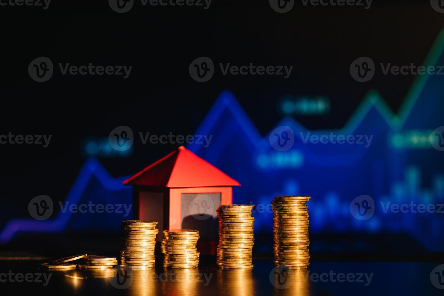 A pile of coins casting a shadow as house, savings concept photo