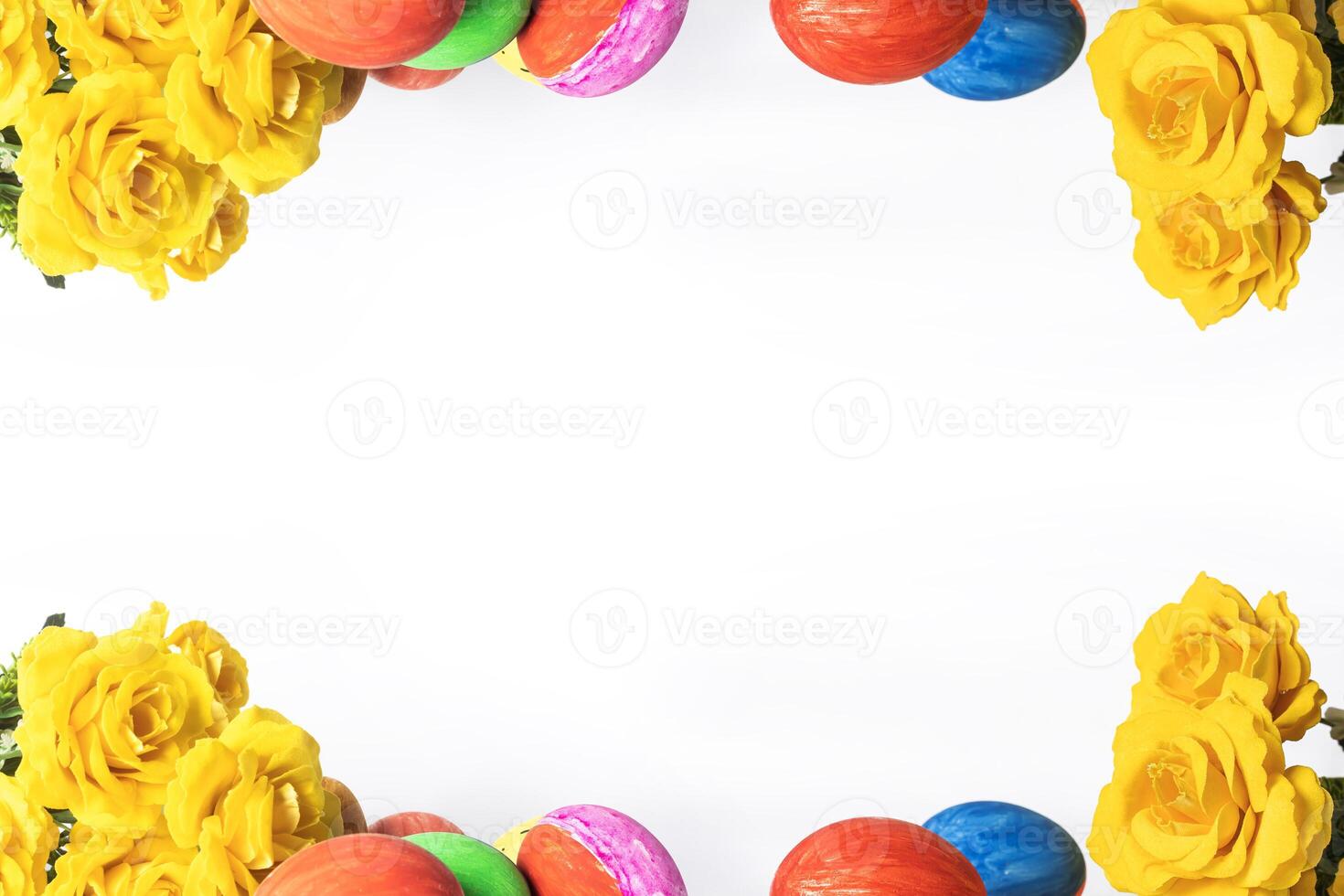 Colorful easter eggs and yellow roses on white background with copy space for text photo