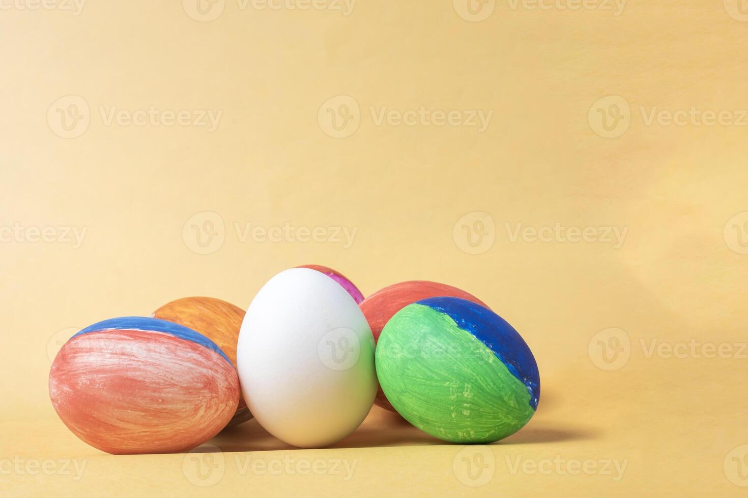 Colorful painted easter eggs on a yellow background with copy space. photo