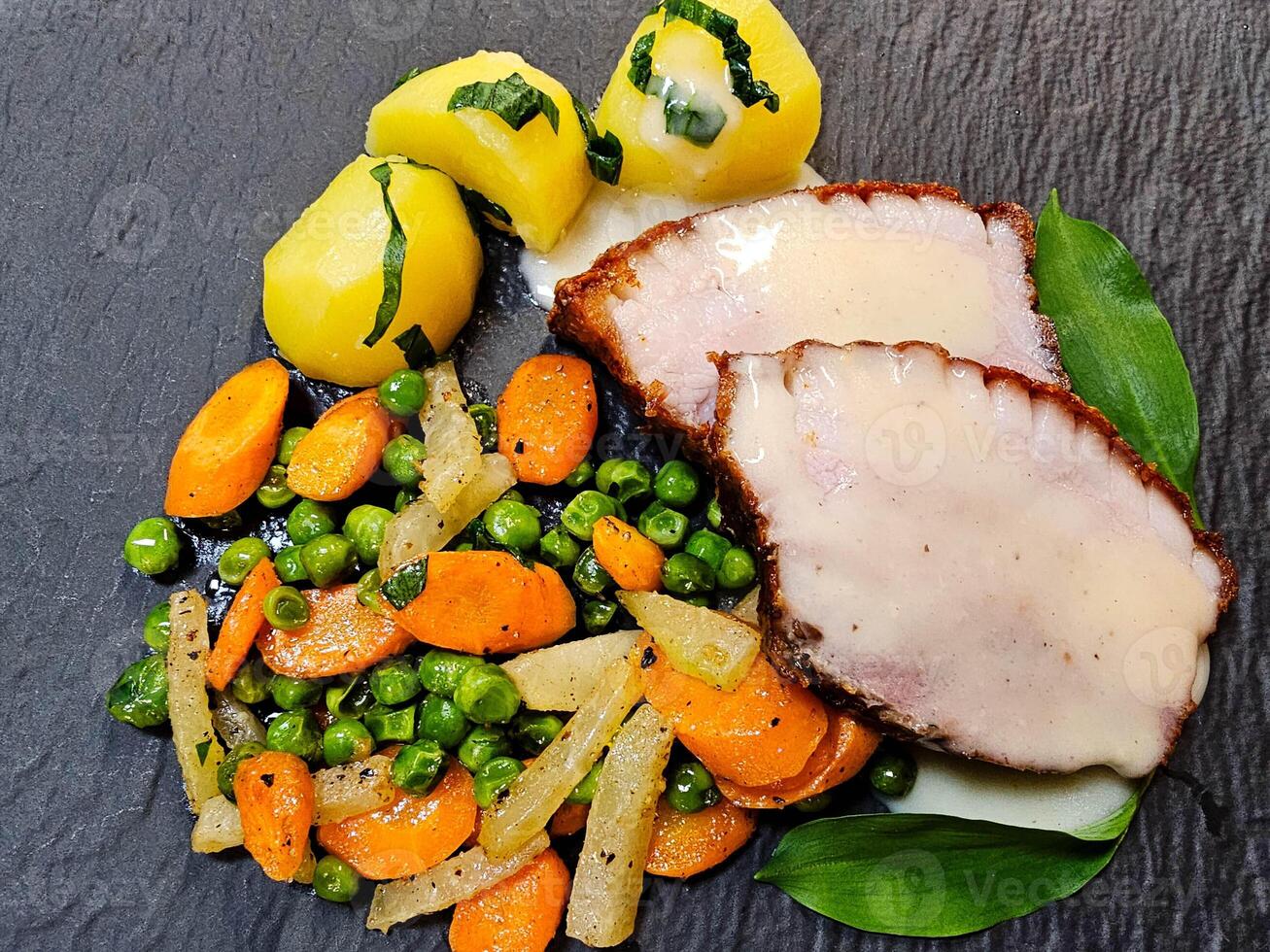 Pork Royal a traditional roast pork with vegetables and wild garlic photo