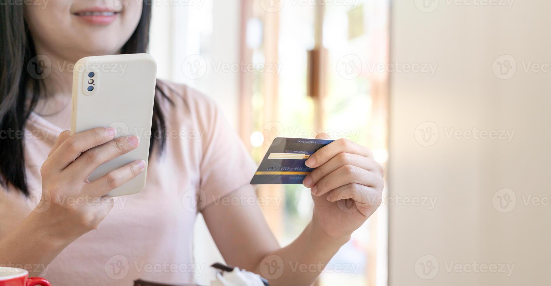 woman using smartphone for online shopping at home. Hand holding mobile phone with payment detail page display and credit card, stay home, technology, electronic commerce, internet, market place photo