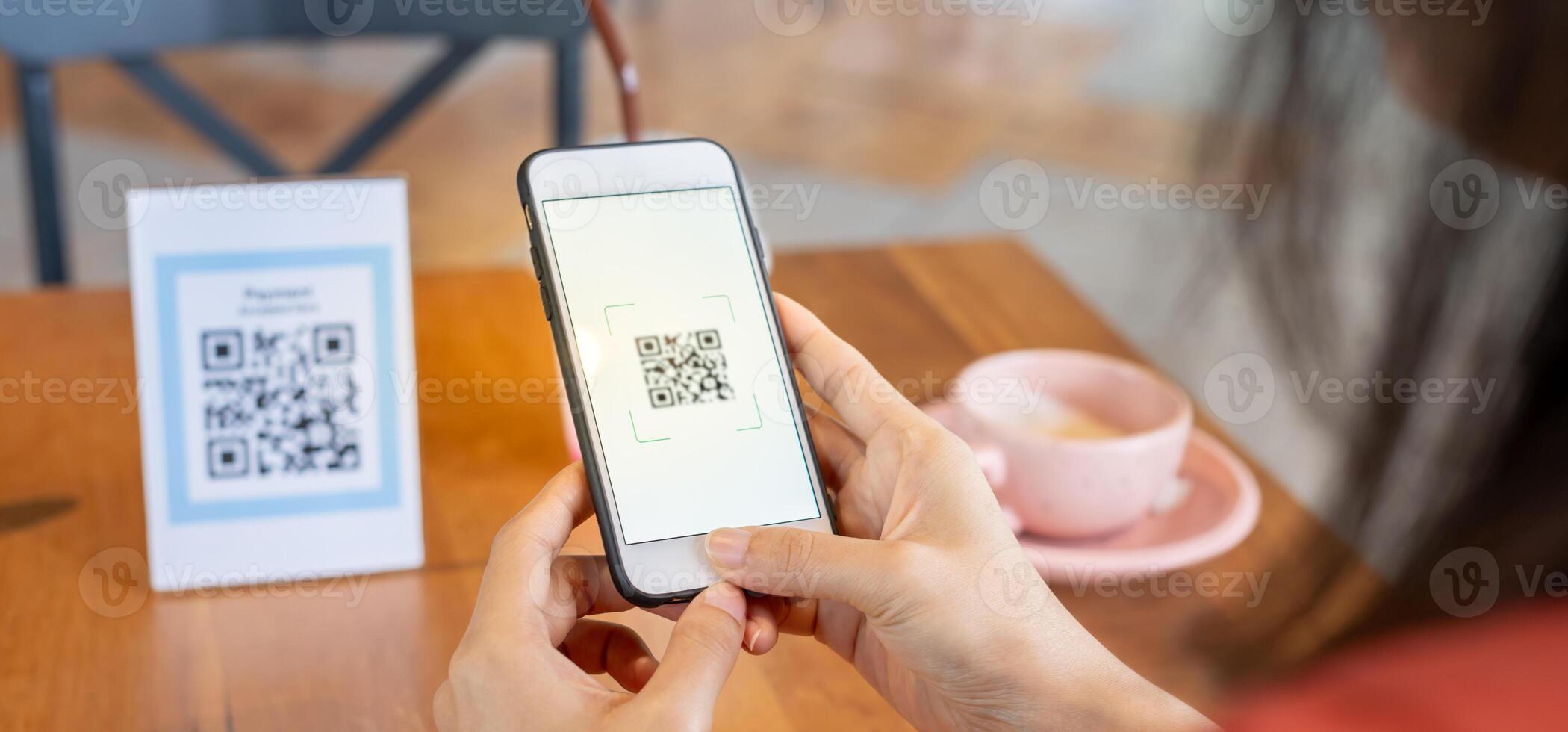 Woman use smartphone to scan QR code to pay in cafe restaurant with a digital payment without cash. Choose menu and order accumulate discount. E wallet, technology, pay online, credit card, bank app. photo