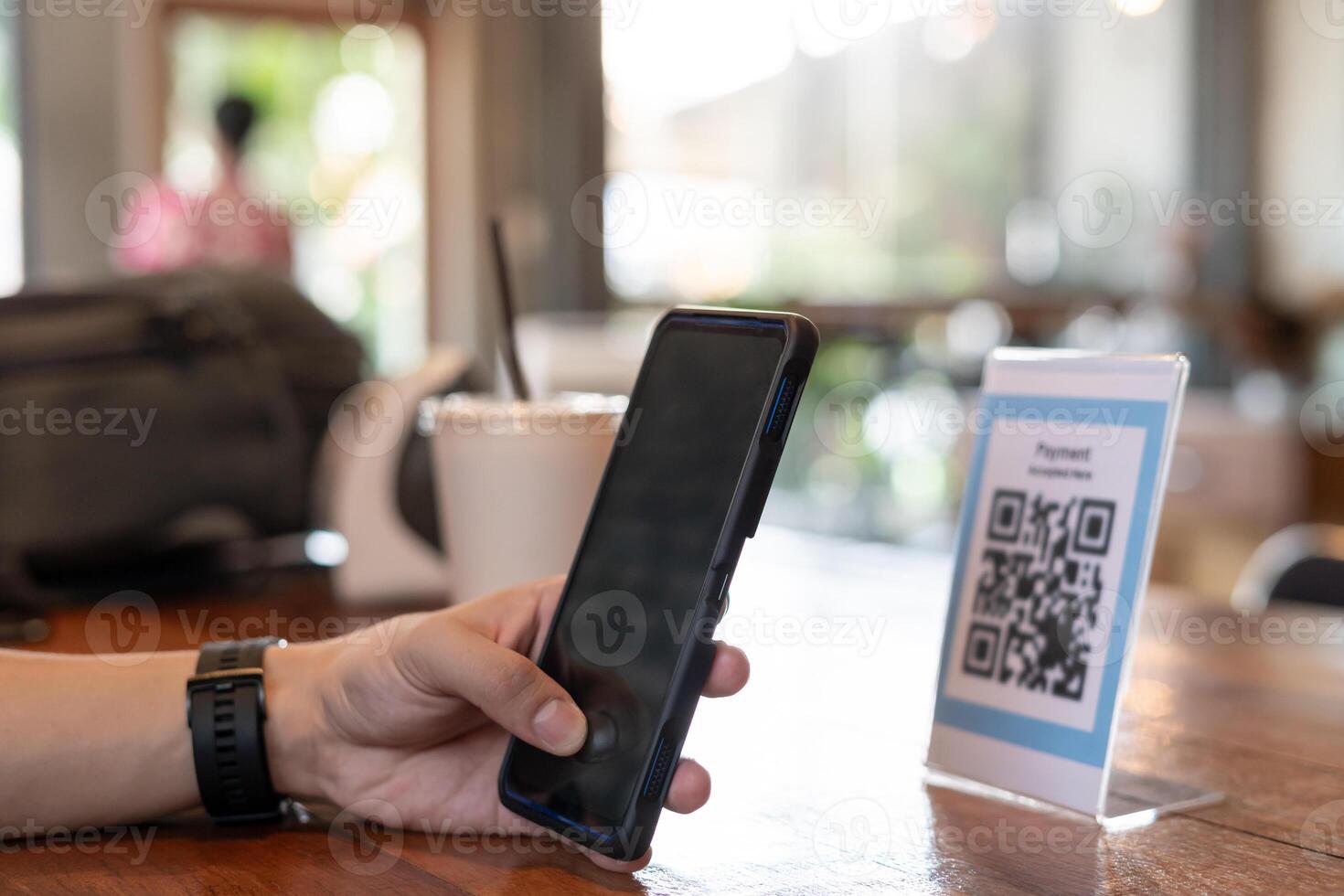 man use smartphone to scan QR code for order menu in cafe restaurant with a digital delivery. Choose menu and order accumulate discount. E wallet, technology, pay online, credit card, bank app. photo