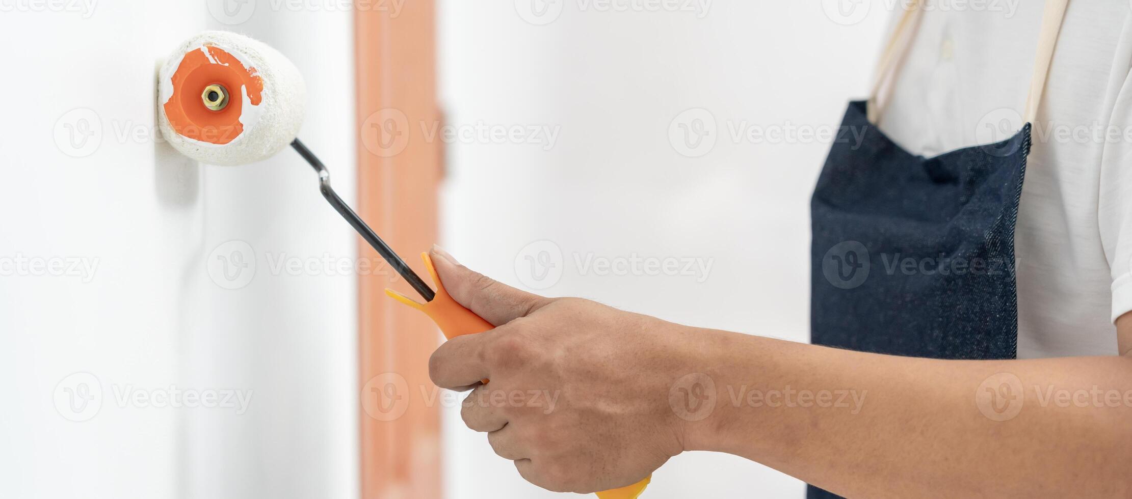 painter man, brush in hand for products to restore and paint the wall, indoor the building site of a house, wall during painting, renovation, painting, contractor, Architect, construction worker photo