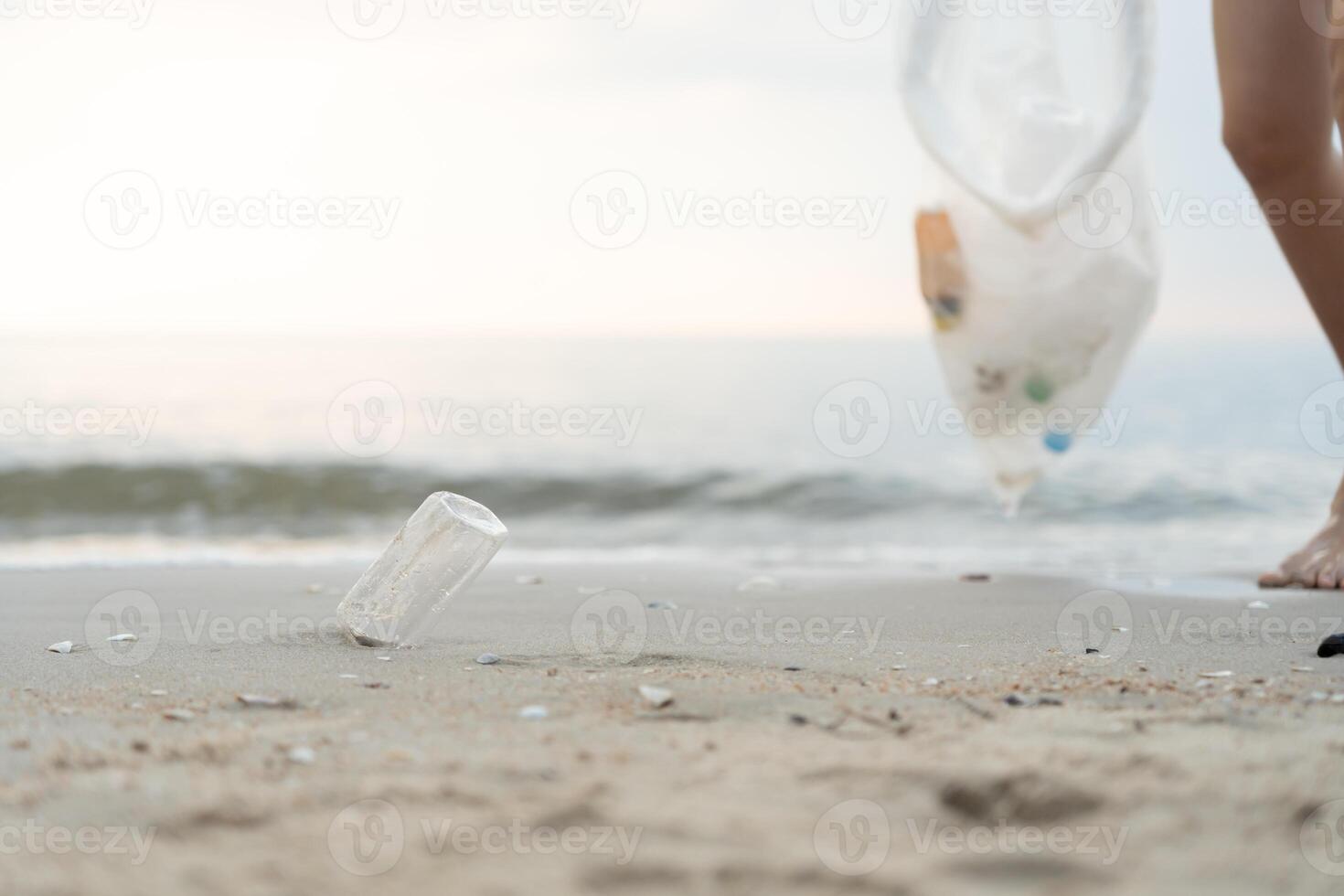 Save water. Volunteer pick up trash garbage at the beach and plastic bottles are difficult decompose prevent harm aquatic life. Earth, Environment, Greening planet, reduce global warming, Save world photo