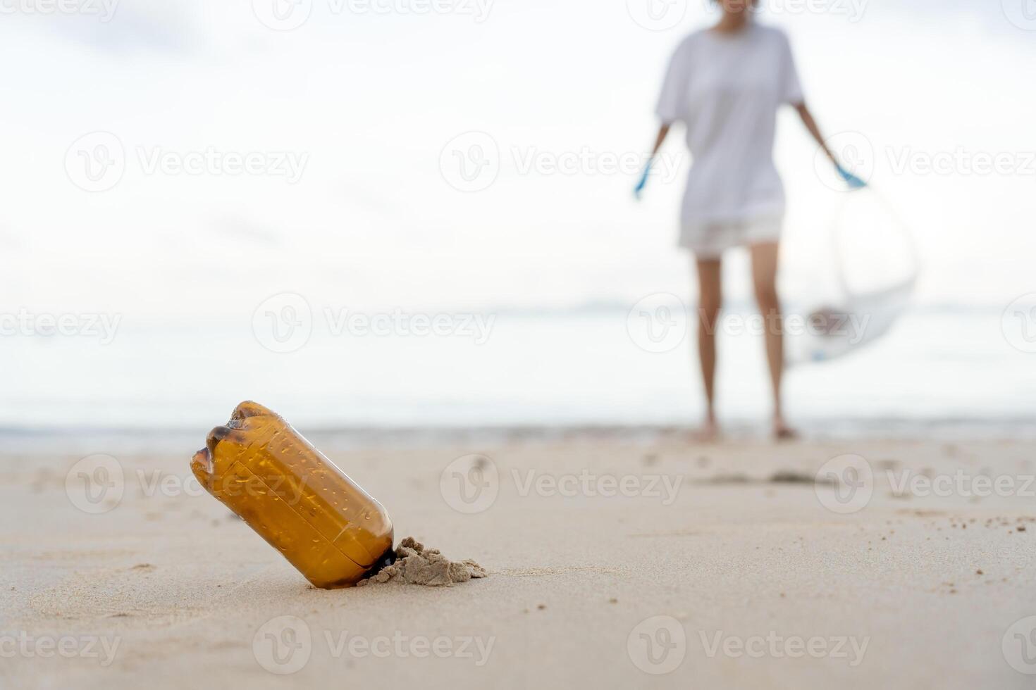 Save water. Volunteer pick up trash garbage at the beach and plastic bottles are difficult decompose prevent harm aquatic life. Earth, Environment, Greening planet, reduce global warming, Save world photo
