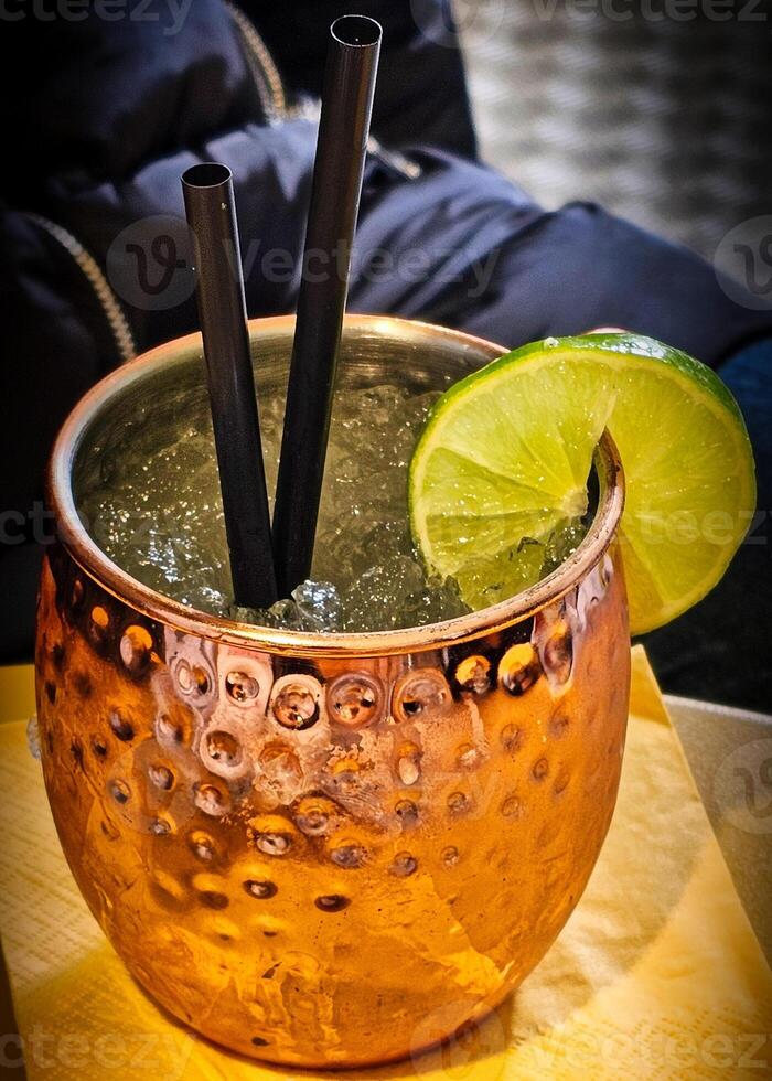 A Moscow mule is a cocktail made with vodka, ginger beer, and lime juice, garnished with a slice or wedge of lime and a sprig of mint. The drink, being a type of buck, is sometimes called buck vodka. photo