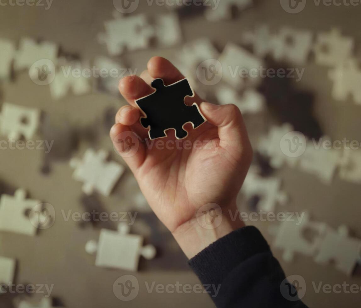 AI generated A man holds a black puzzle piece against a background of many whites photo