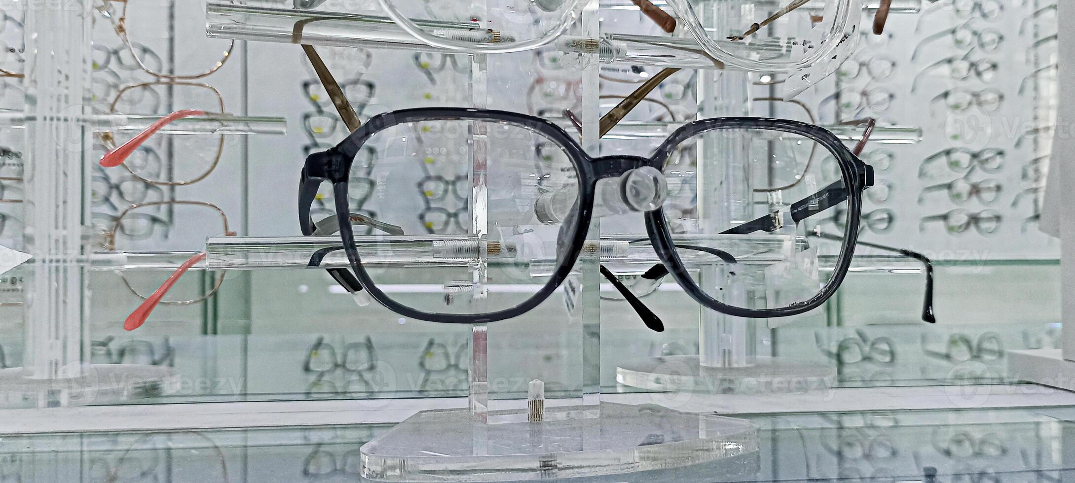 Eyeglasses exhibition on shelves Fashionable eyeglasses displayed on the wall at an eyeglasses shop photo