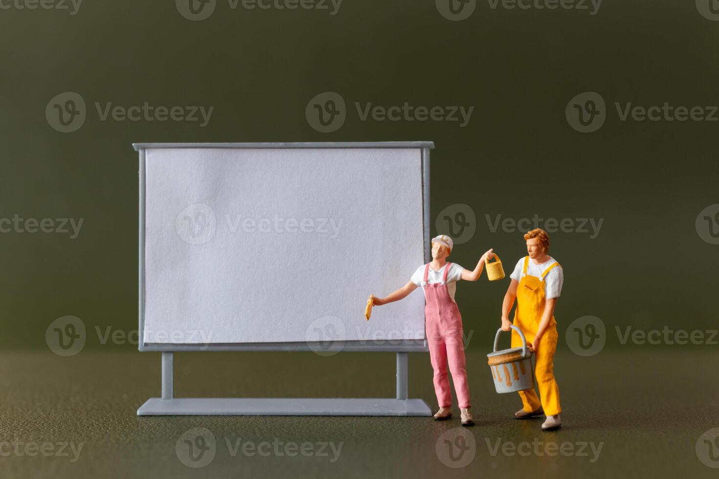 Tiny figures , A blank canvas and an imaginative artist brainstorming ideas in an art class or studio photo