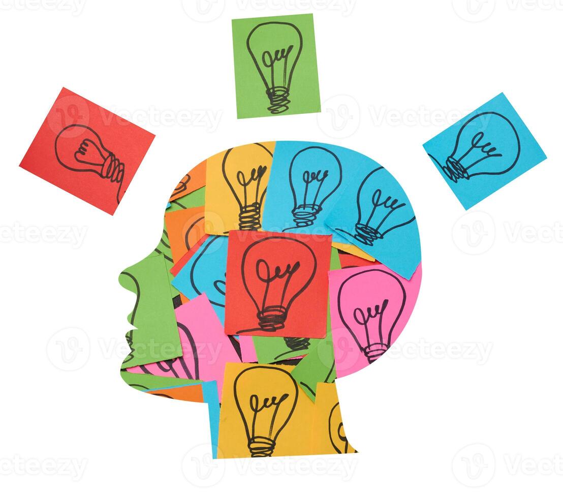 Silhouette of a human head and stickers with drawn electric lamps, search for new ideas and solutions photo