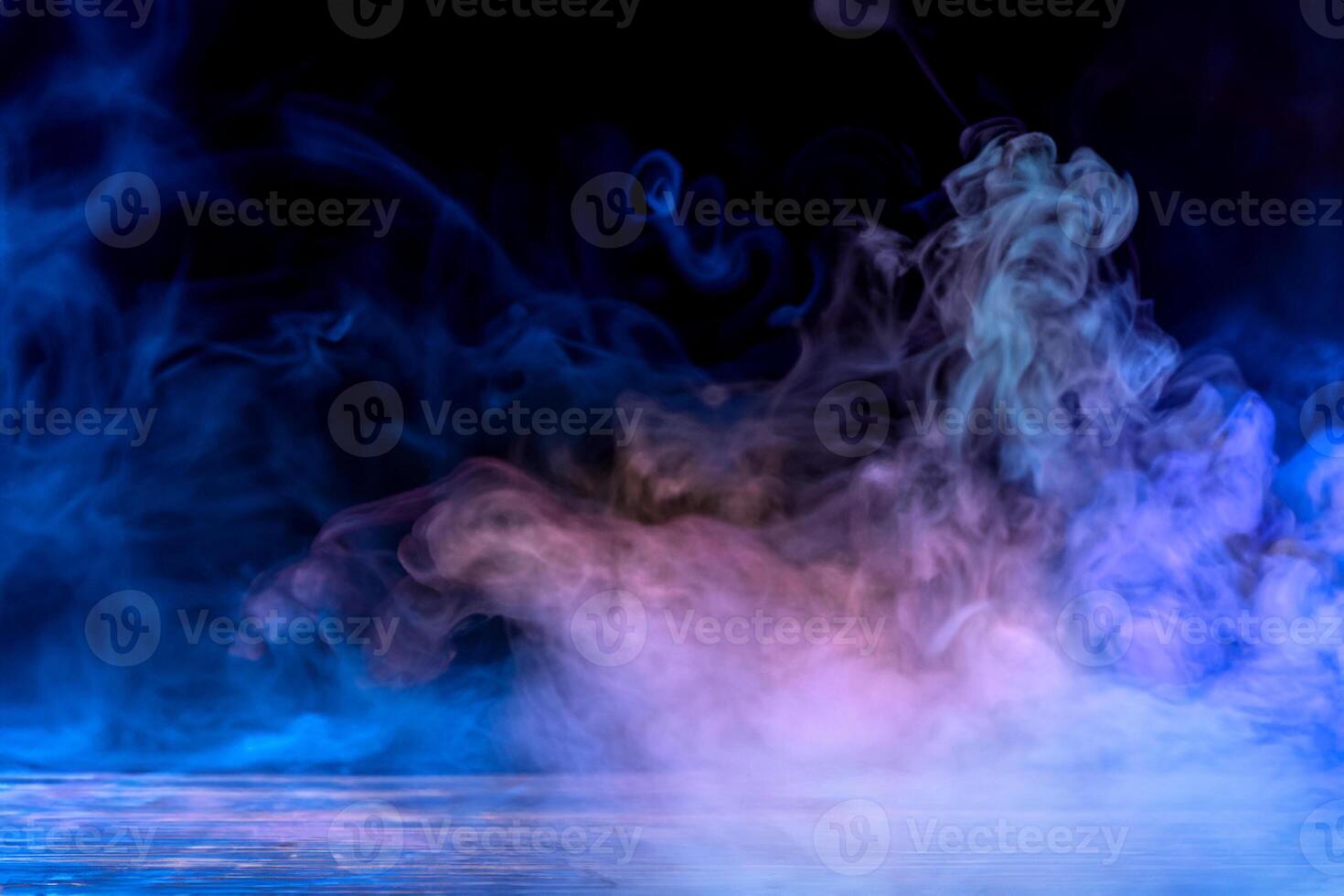 Vibrant Colored Smoke Art on Wooden Table with Dramatic Black Background. photo