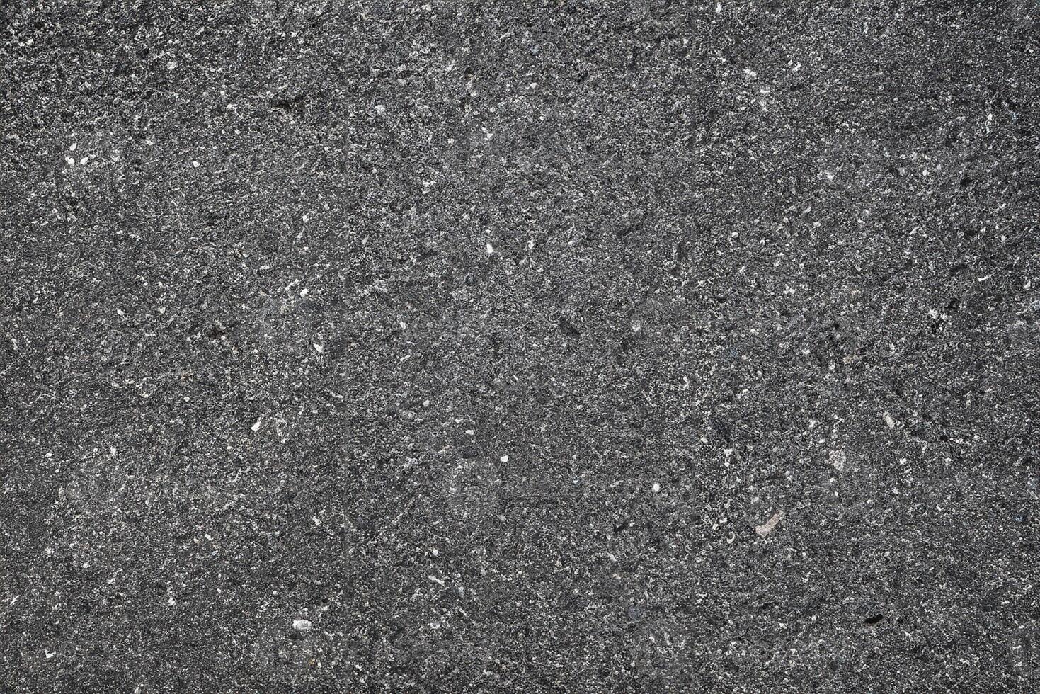 Texture of Dark Asphalt Road with Embedded Rocks, Urban Ground Background. photo