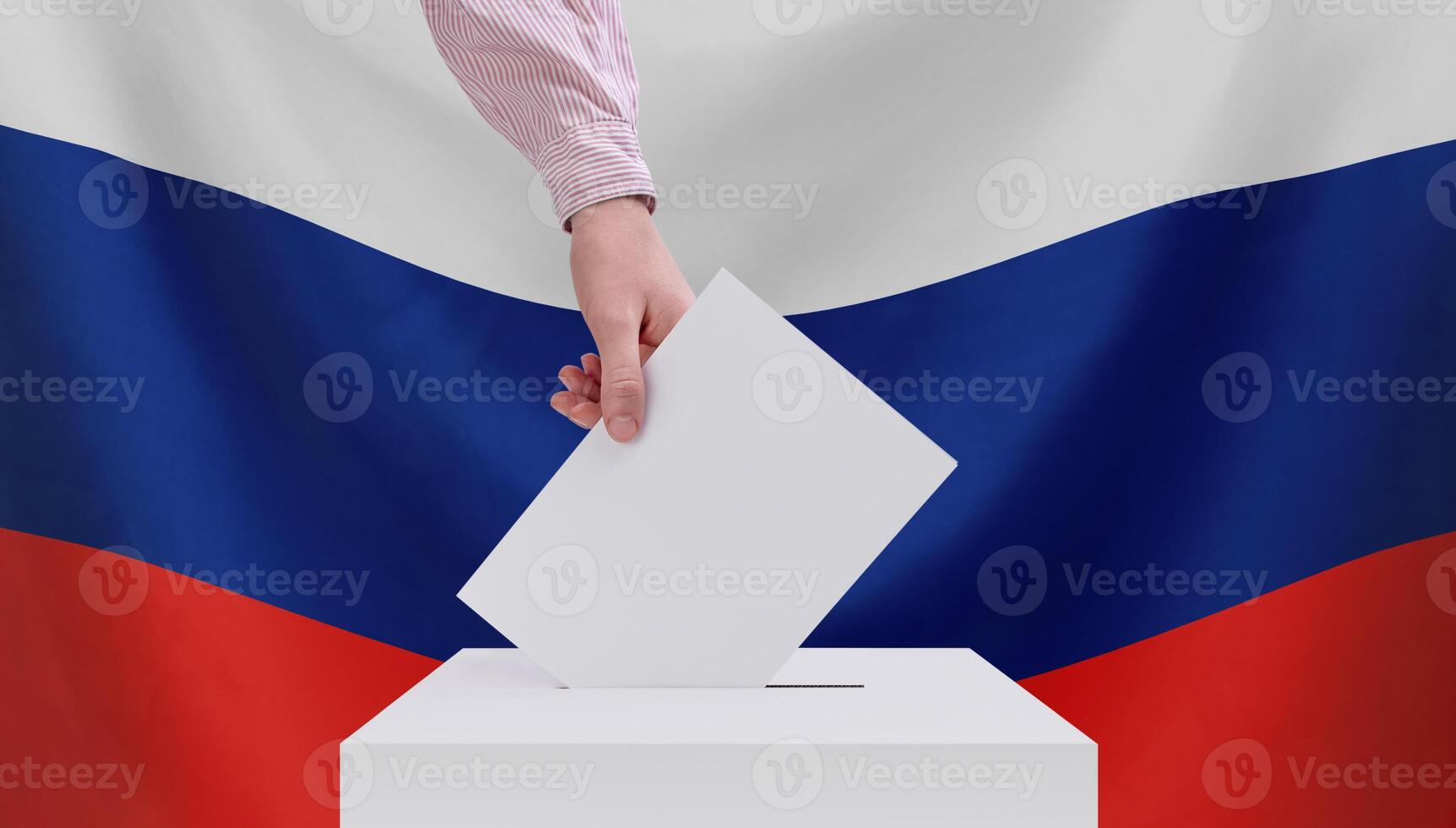 Elections, Russia. The concept of elections. A hand throws a ballot into the ballot box. Russian flag on the background. photo