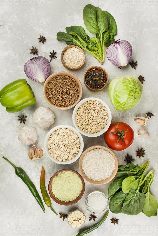 Groats and vegetables on a light table. Healthy eating Great food. Vegetarian food. Food background. photo