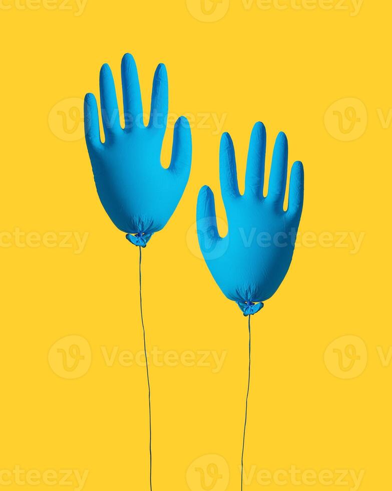 Cleaning concept. Gloves for cleaning in the form of an inflatable ball on a yellow background. Creative idea. photo