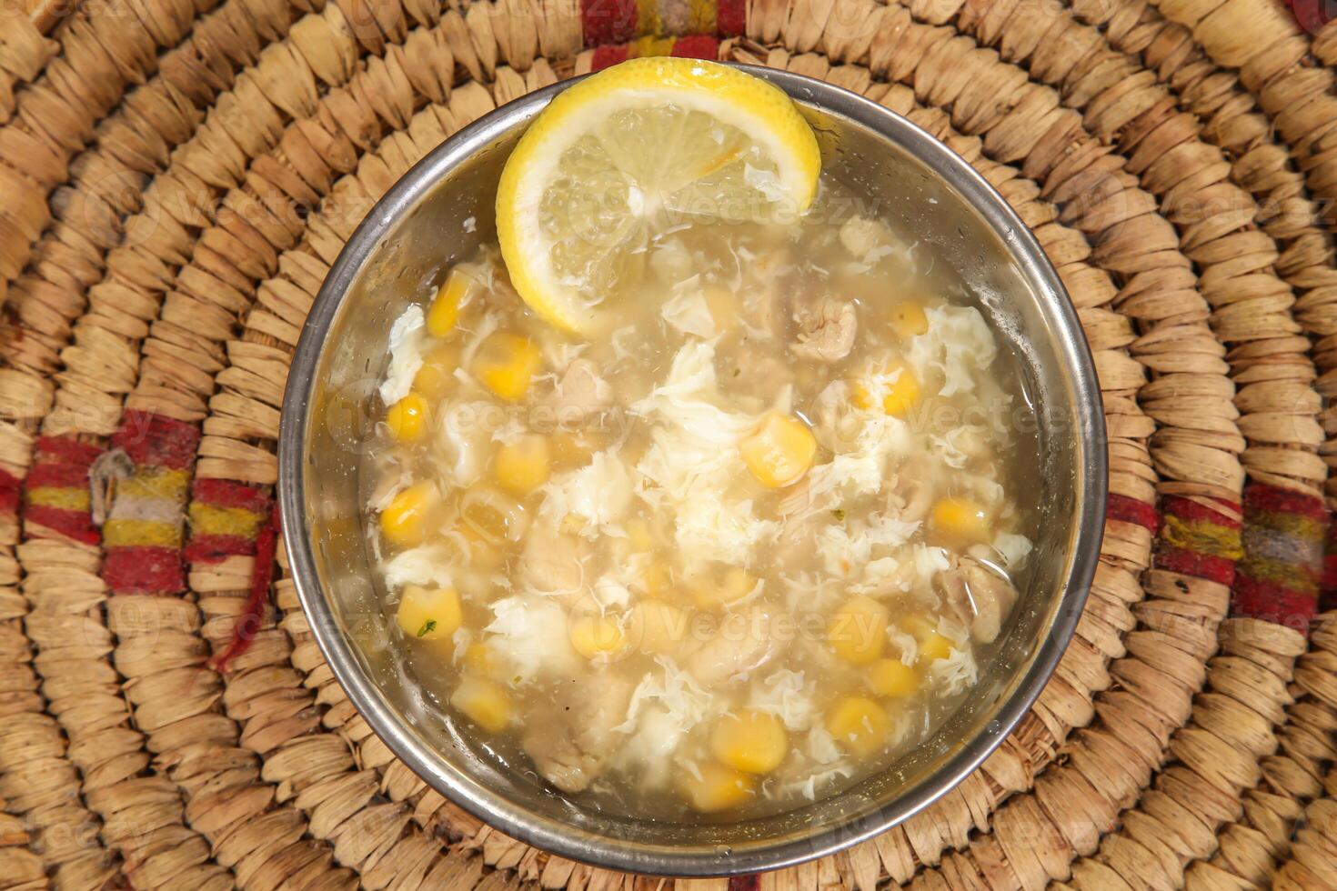 Chicken Corn Soup with lemon served in bowl isolated on background top view arabic style photo