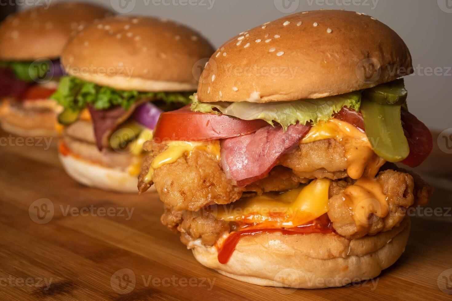 Assorted Burgers with Crispy Chicken Cheese burger with beef bacon isolated on wooden table top view of frech fastfood photo