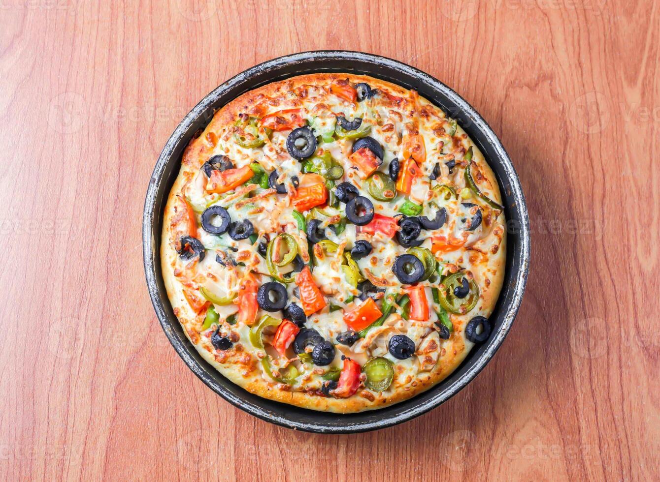 Chicken Fajita Pizza isolated on wooden background, spiced chicken cubes and cheese combination on bread, Italian food top view photo