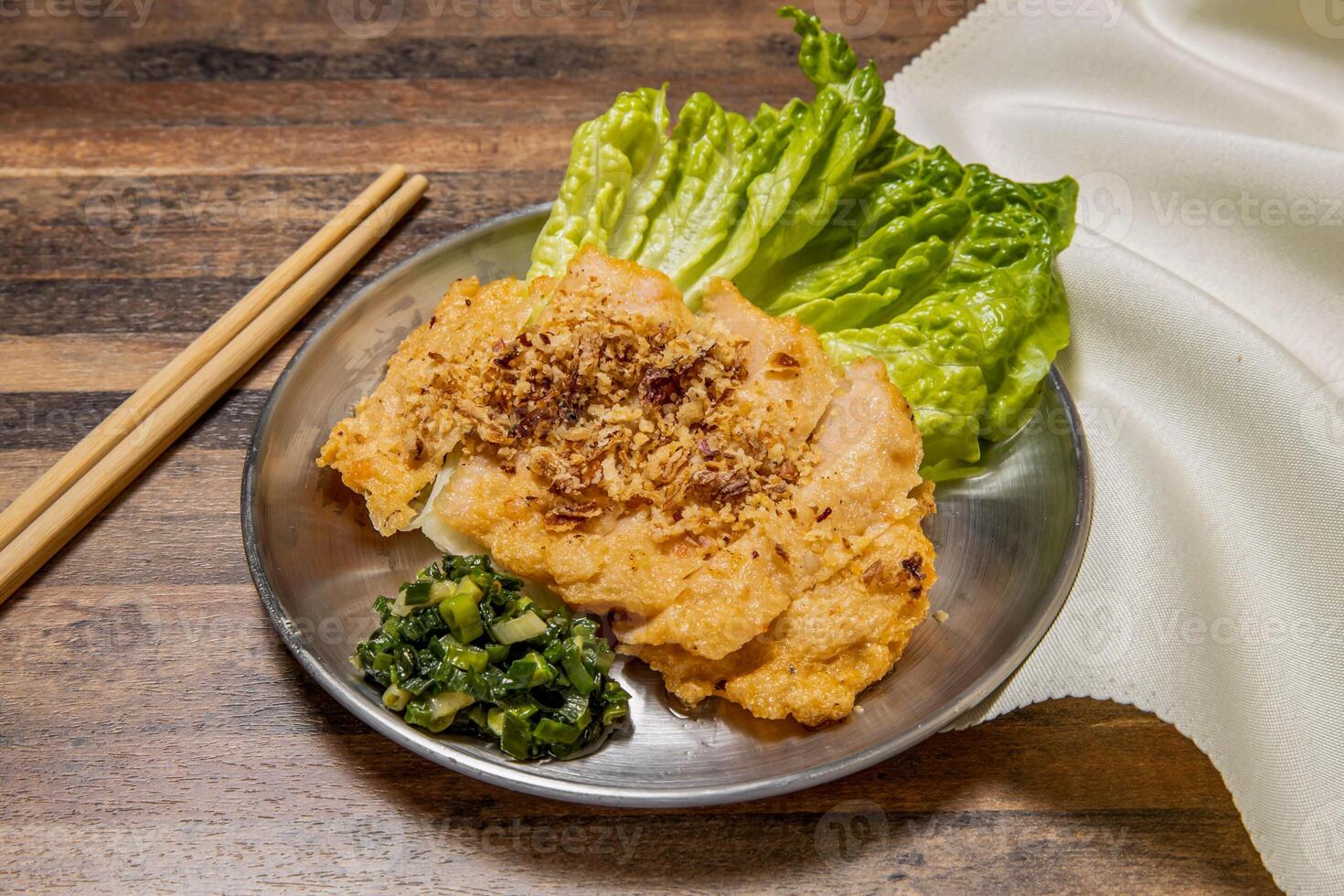 Crispy Fried Shrimp Cake with lettuce leaf, spring onion and chopsticks served in dish isolated on wooden table top view of hong kong fast food photo