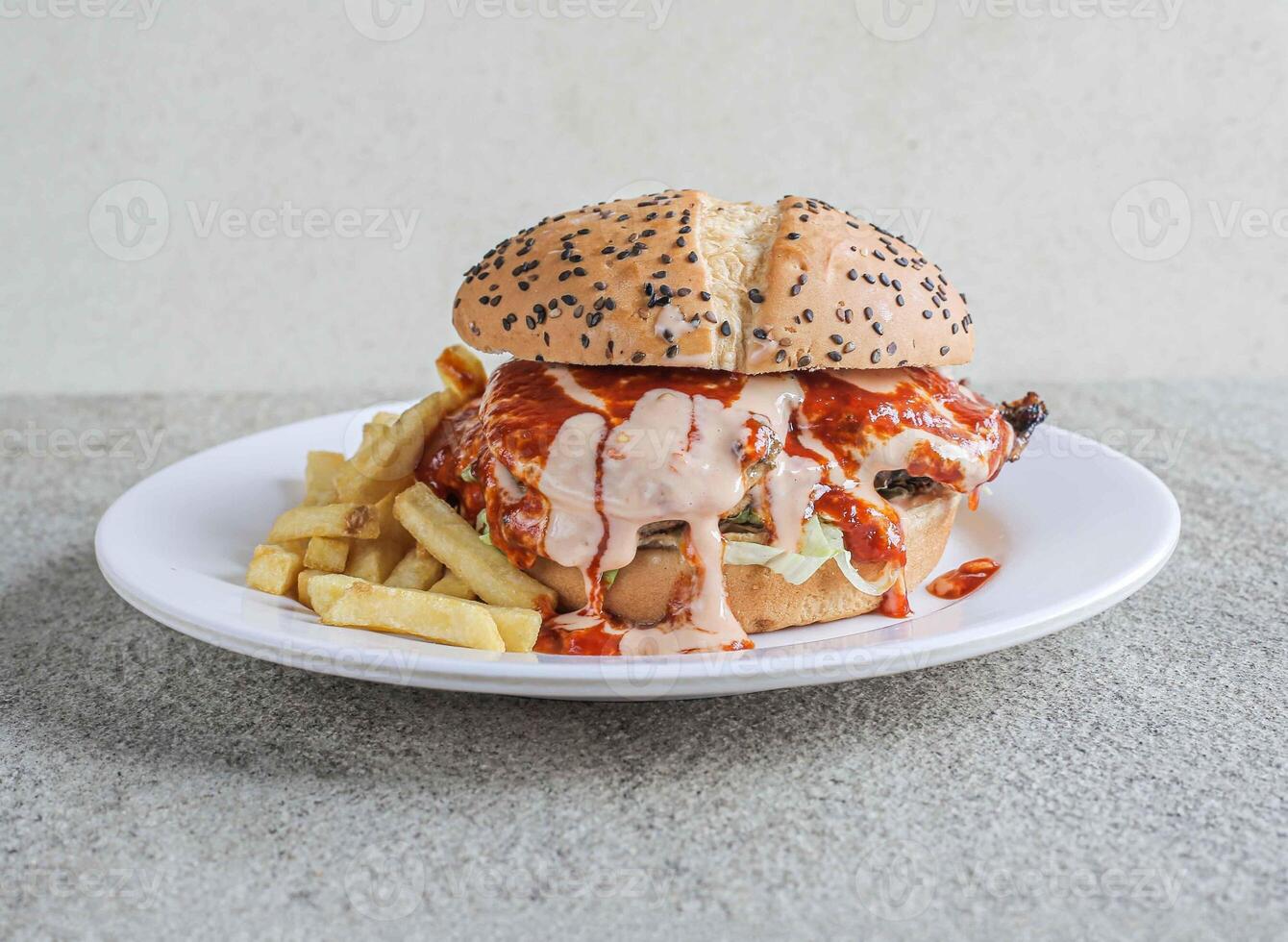 Juicy chicken epic burger served in a dish isolated on grey background side view of fast food photo