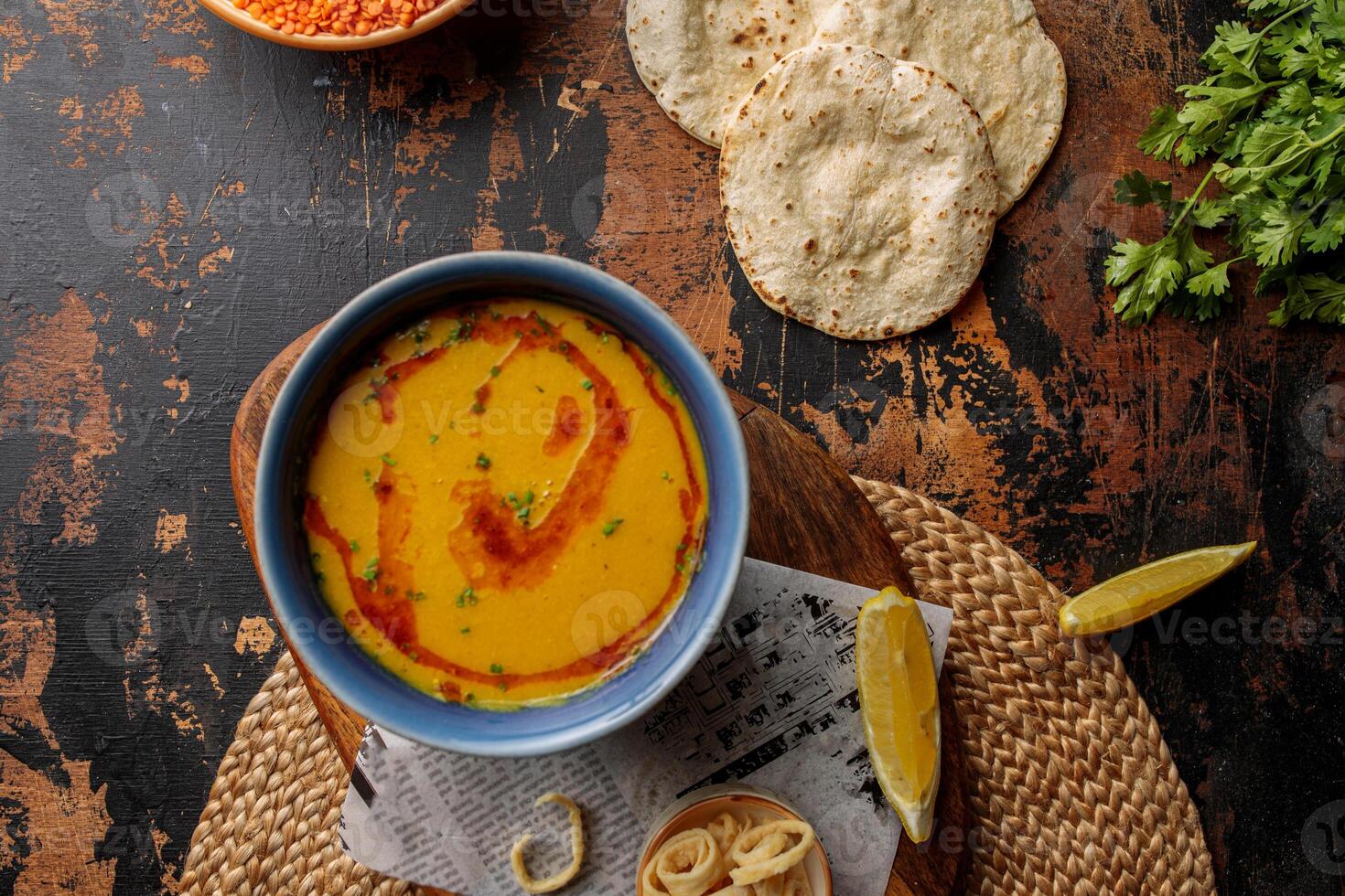 Bahraini Red Lentil soup with lime and bread served in dish isolated on table top view of arabic breakfast photo