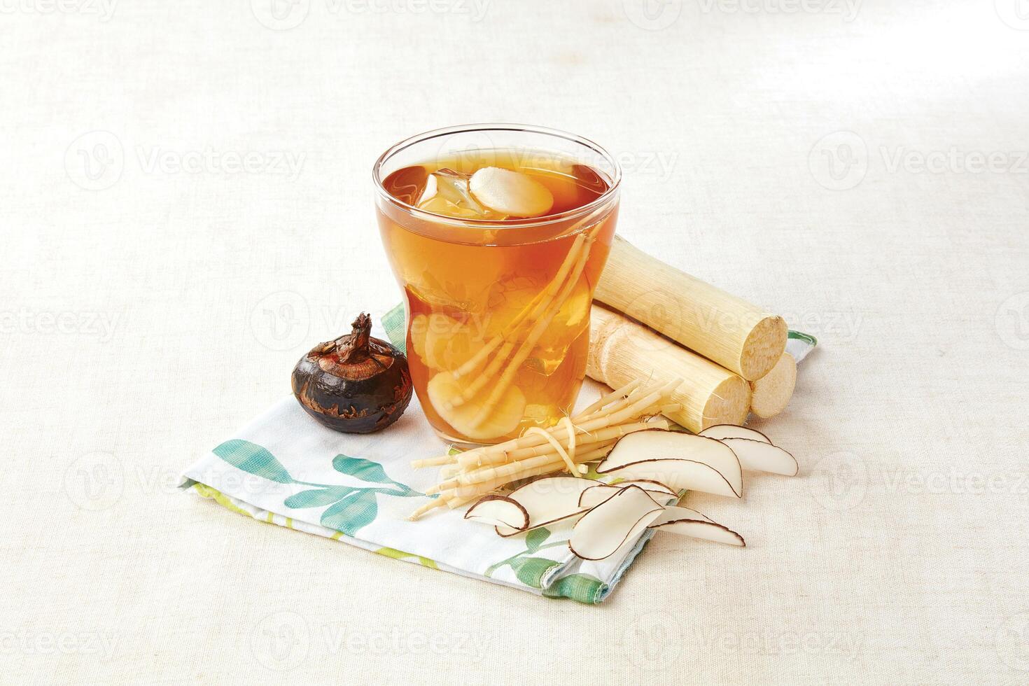 Bamboo Cane, Chuck Root and Horseshoe Sea Coconut Drink served in a cup isolated on napkin side view of hong kong food photo