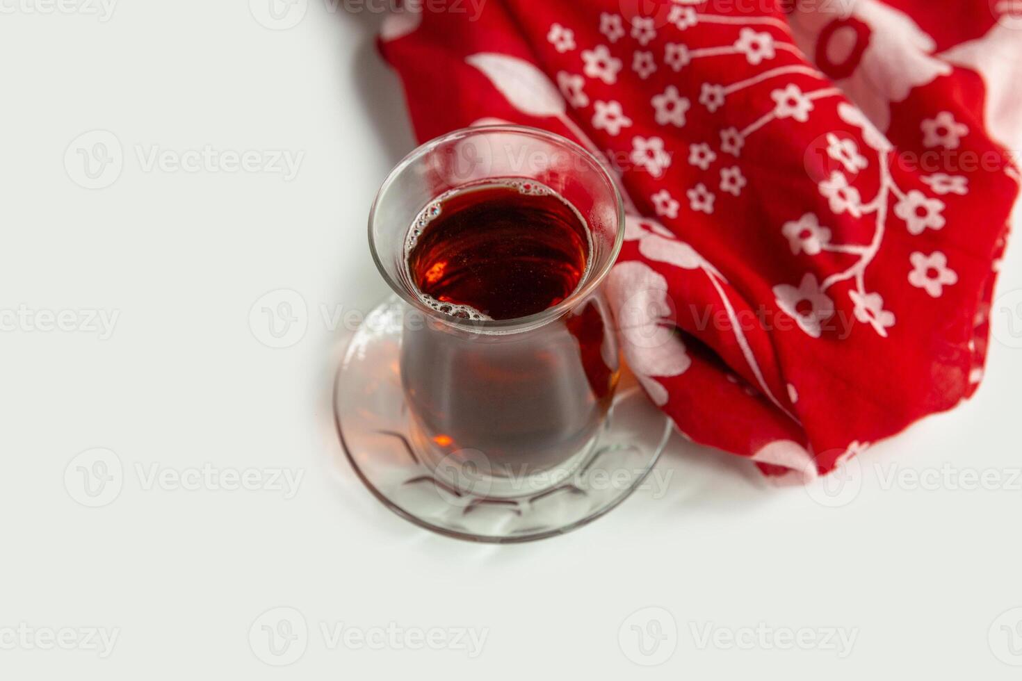 Cup of apple tea isolated on colorful table cloth top view on grey background photo
