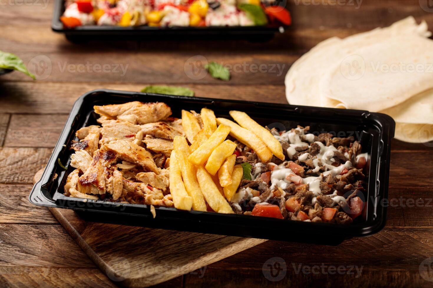 Mix Shawarma plate served in a dish isolated on wooden table background side view of fastfood photo