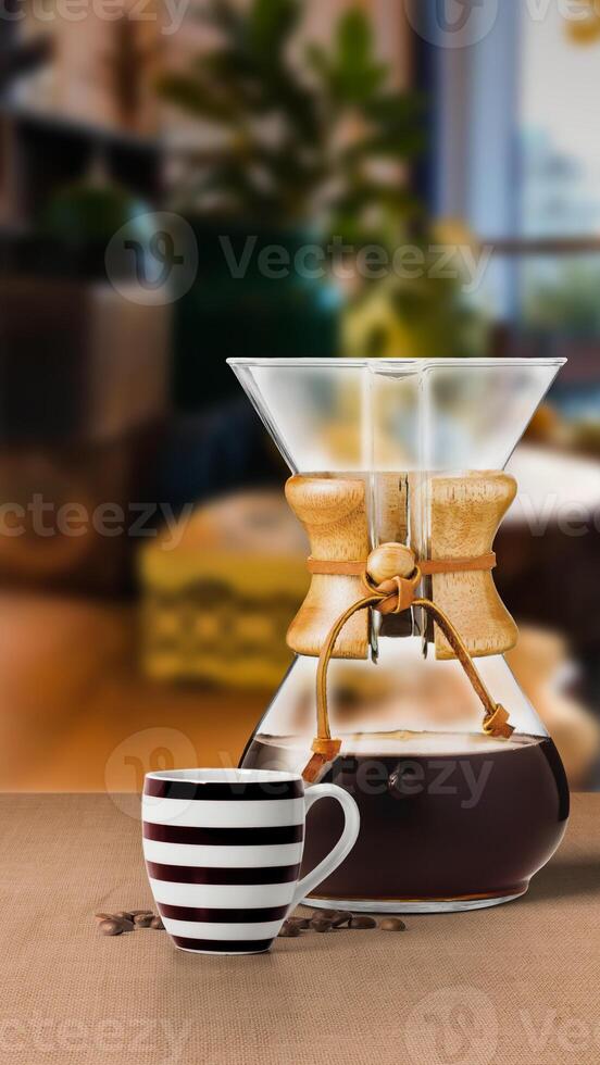 CHEMEX COFFEE maker filter with black coffee cup isolated on table side view photo