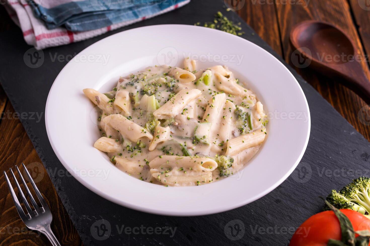 White creamy pasta served in dish top view on dark background american fast food photo