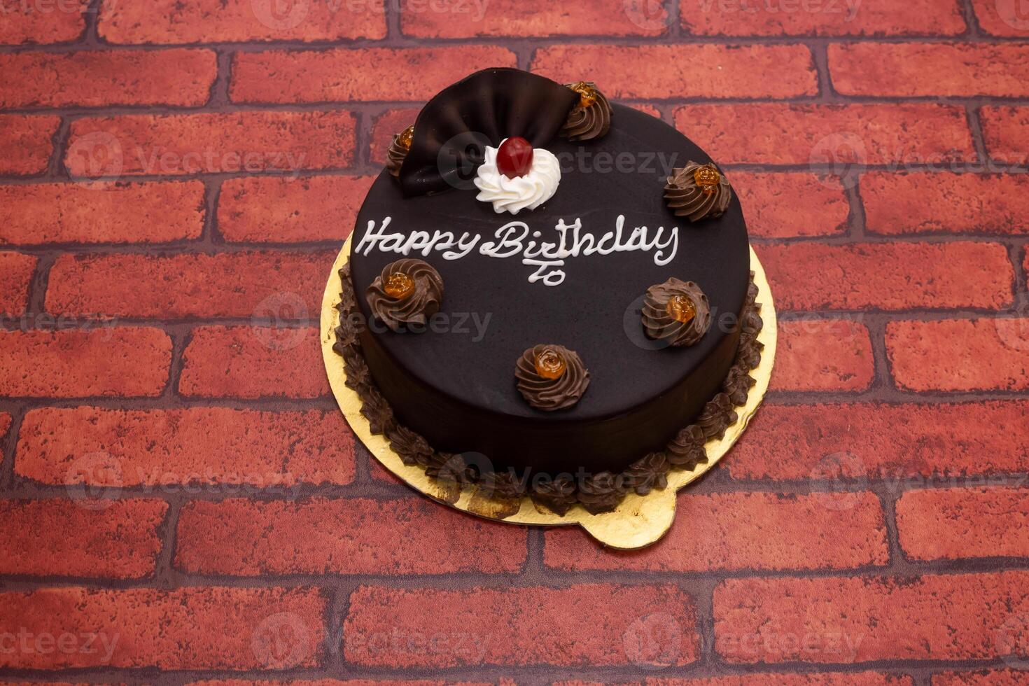 Chocolate cake topping with happy birthday writing served in plate isolated on background top view of bangladeshi dessert food photo