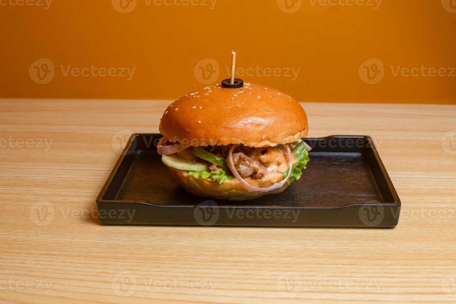 Beef Burger served in dish isolated on table top view of fastfood photo