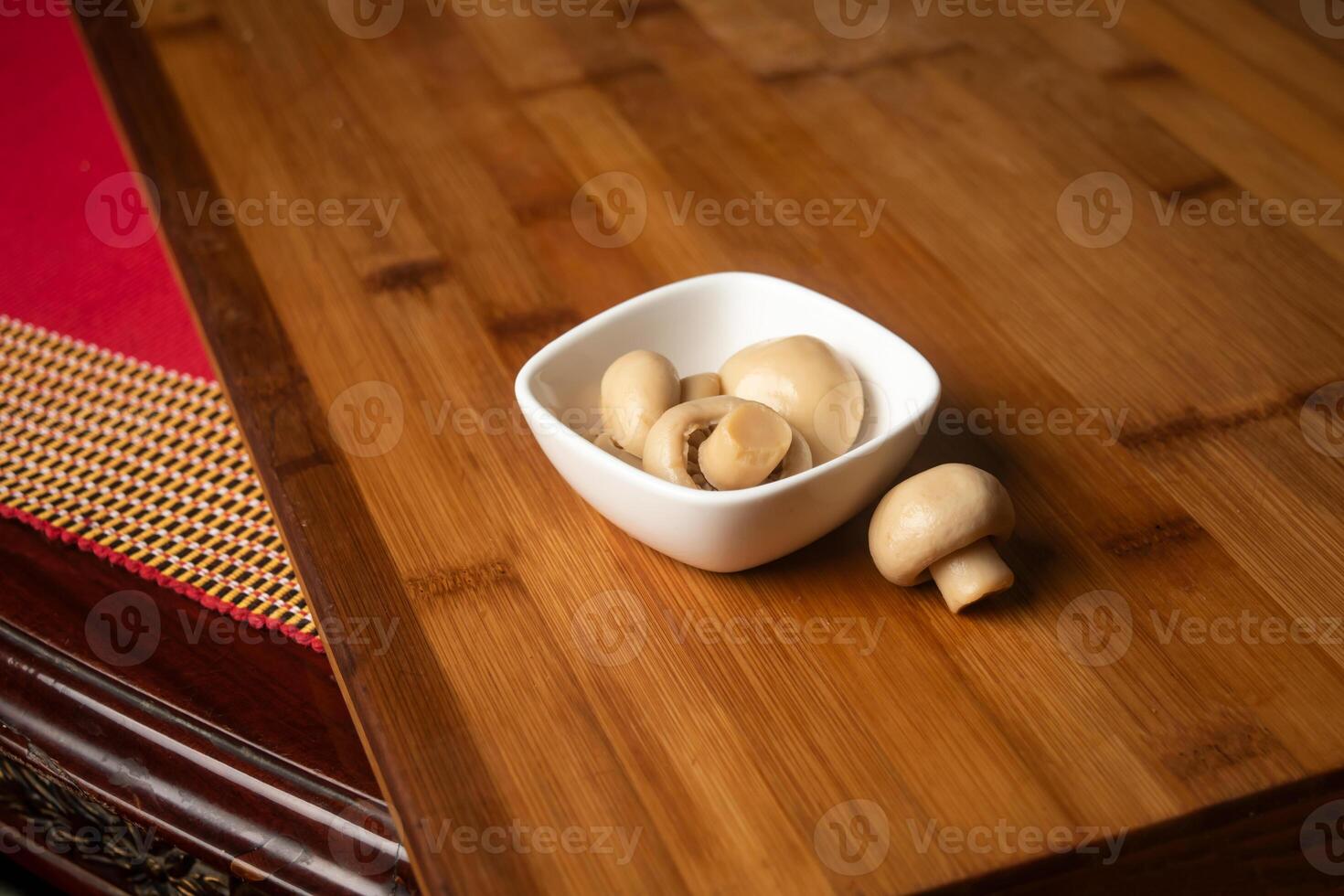 Fresh Mushroom served in bowl isolated on wooden table top view of indian food photo