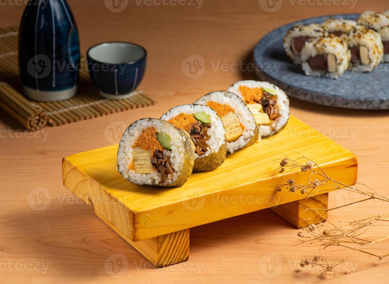 Japanese classic roll served isolated on wooden board top view of japanese food photo