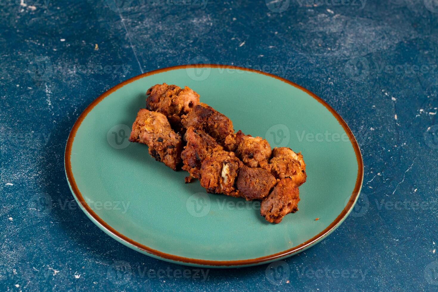 spicy bbq chicken tikka boti kabab served in a dish isolated on background top view photo