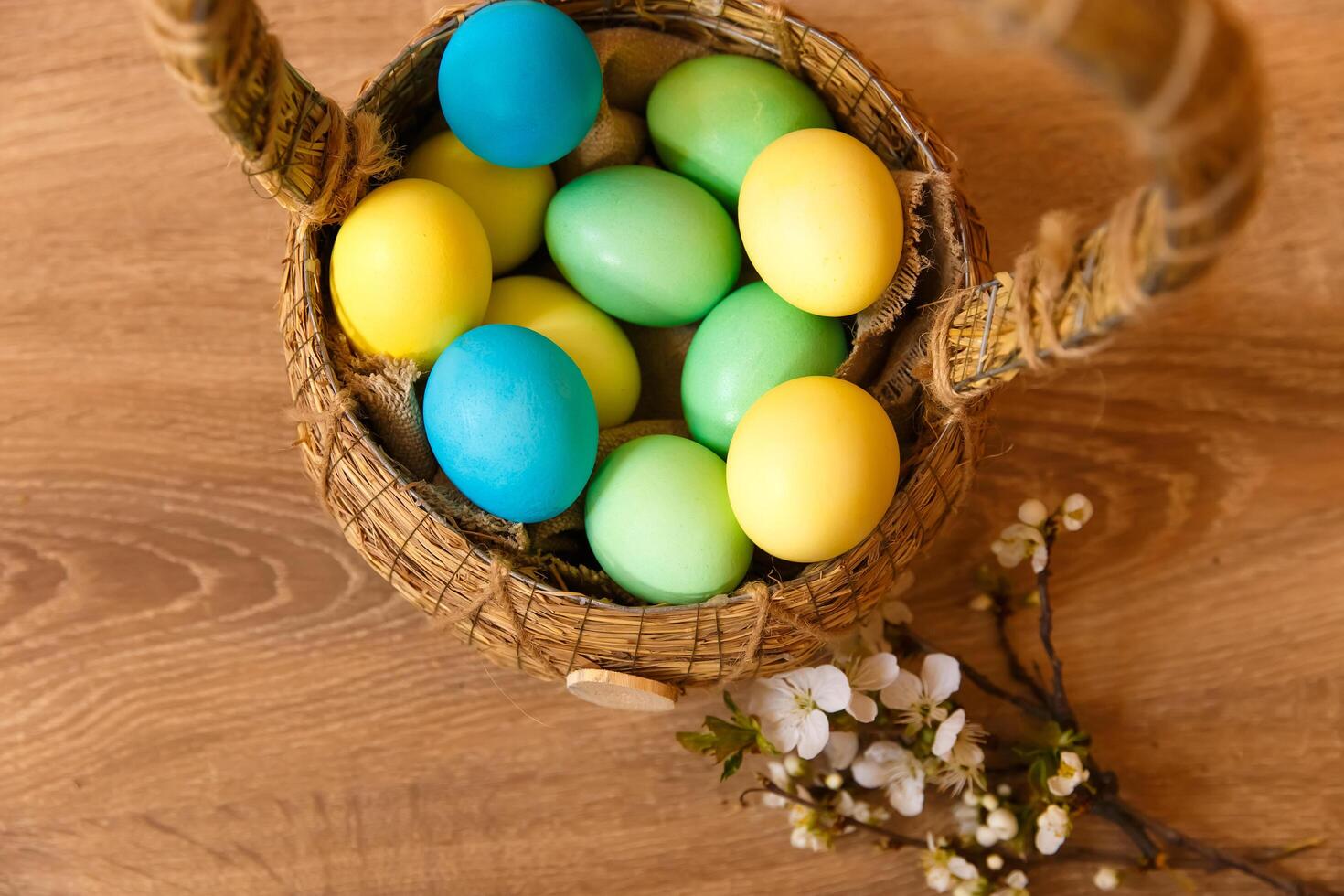 Paint eggs for Easter, bright Easter holiday, children paint eggs, colored eggs in a basket, colored eggs on a stand, Holiday background photo