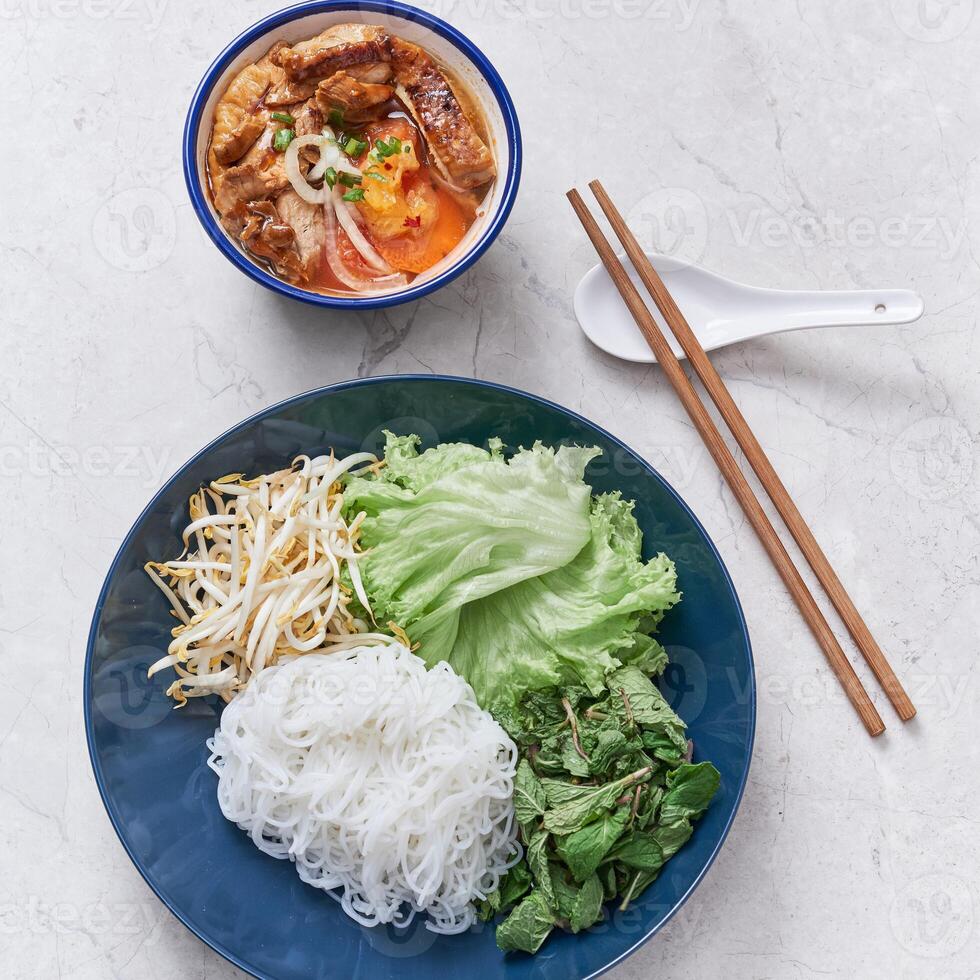 Chicken Bun Cha with noodle, roll and salad served in a dish isolated on grey background side view of vietnam food photo