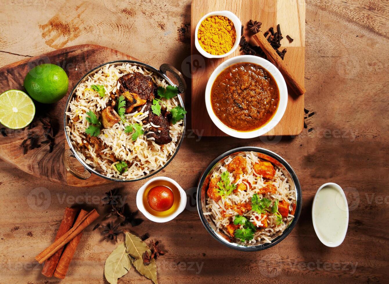 Indian spicy Lamb Shank Biryani, Butter Chicken Biryani with gravy, lime raita and gulab jamun Served in a dish side view on grey background photo