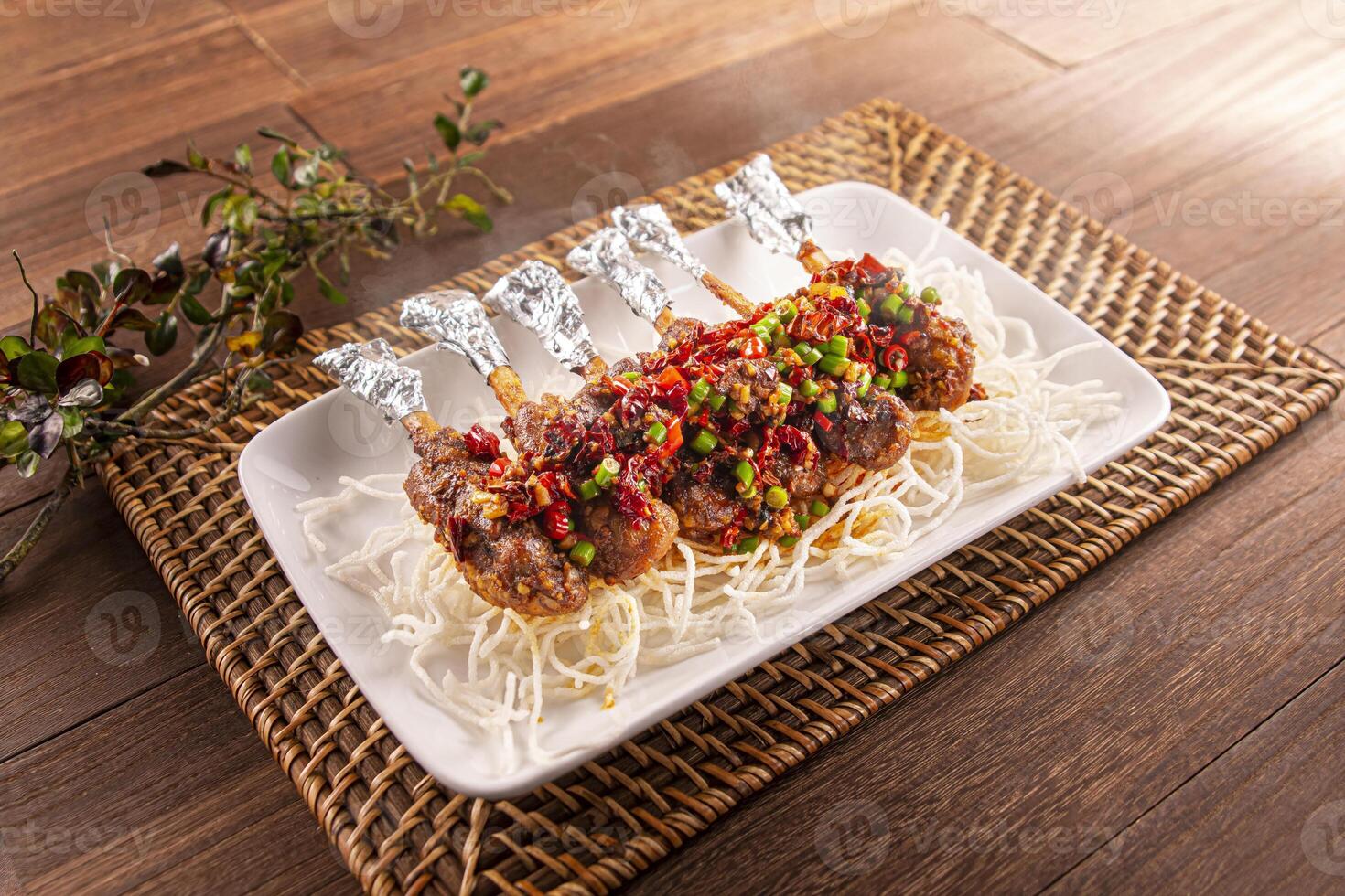 Spicy chili Cumin Pork Knuckle served dish isolated on wooden table top view of Hong Kong food photo