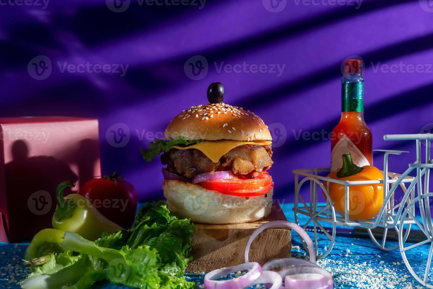 Chicken Cheese Burger with tomato, ketchup and green chilli isolated on wooden board side view of american fast food photo