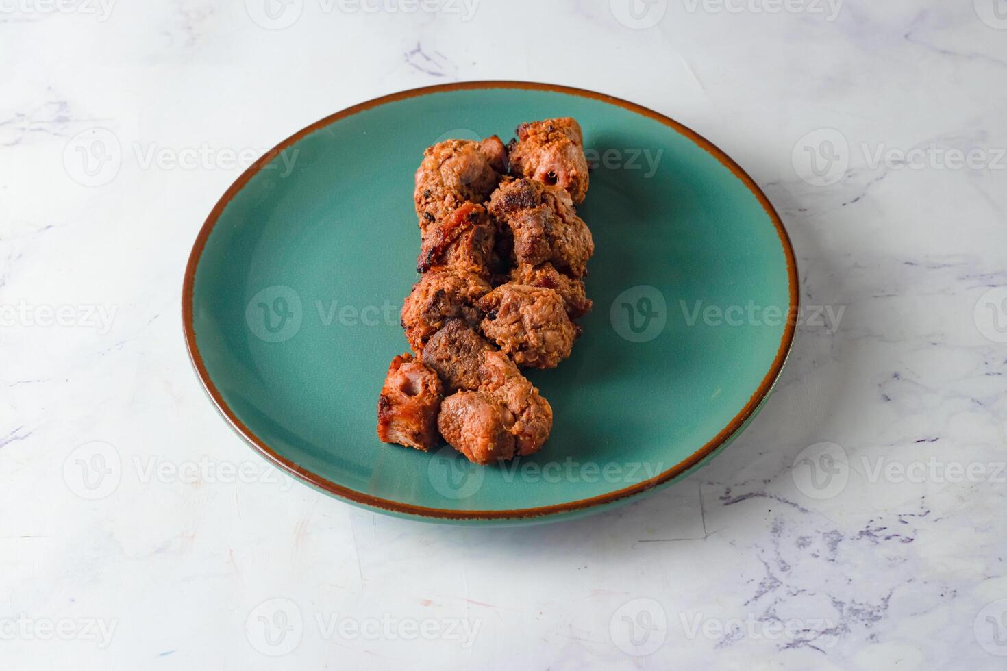 spicy bbq chicken tikka boti kabab served in a dish isolated on background top view photo