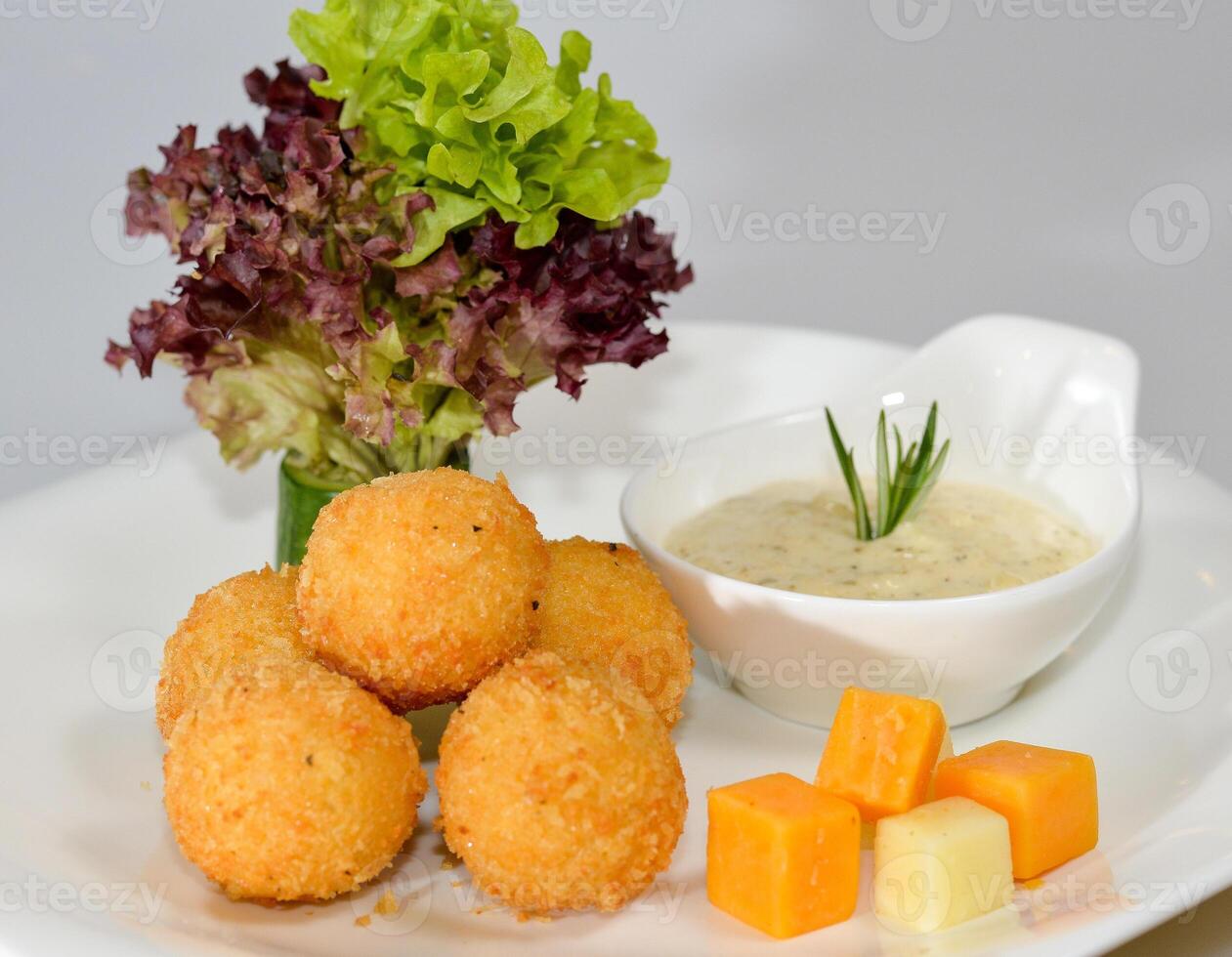 Cheese balls with dip served in a dish isolated on table side view photo