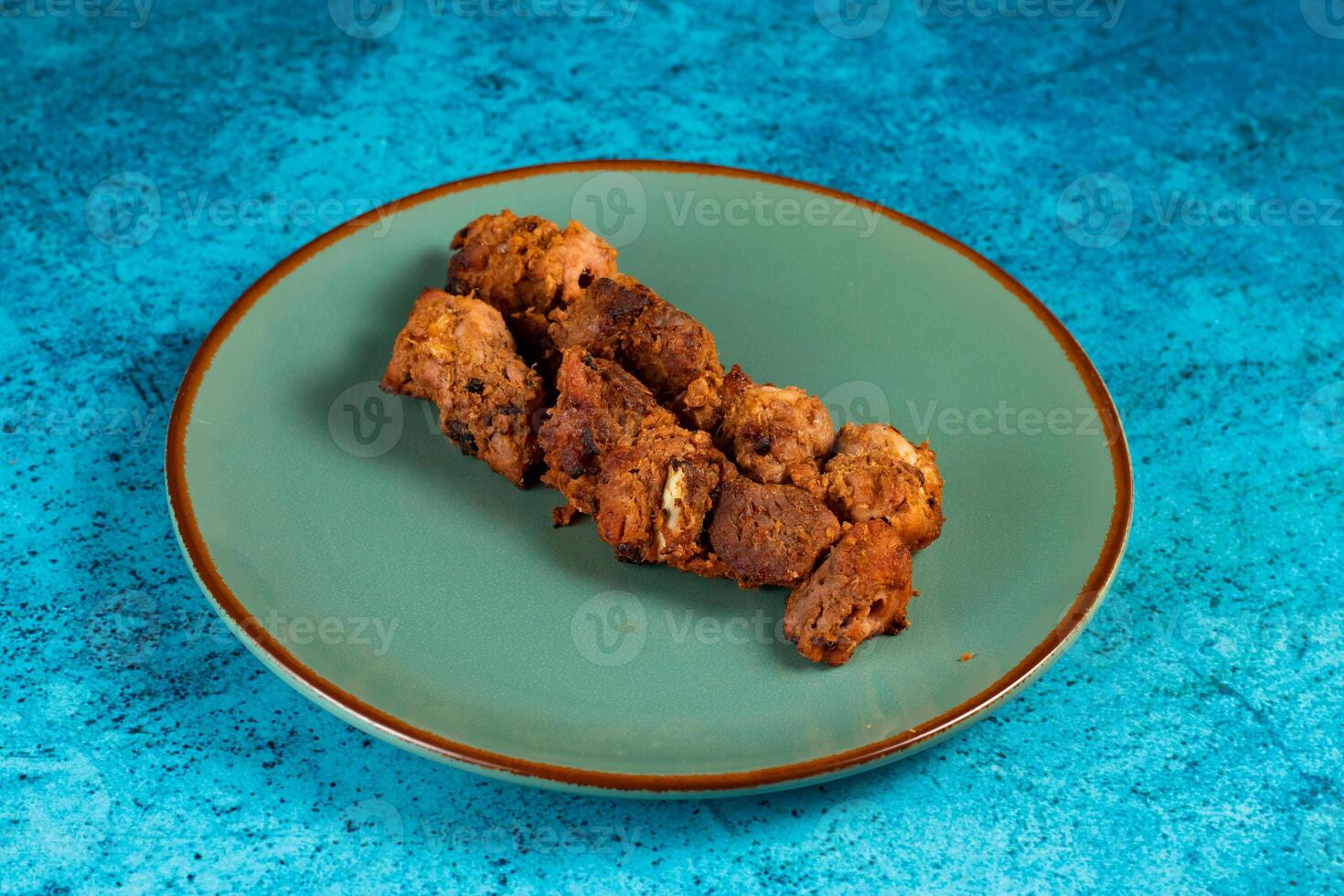 spicy bbq chicken tikka boti kabab served in a dish isolated on background top view photo