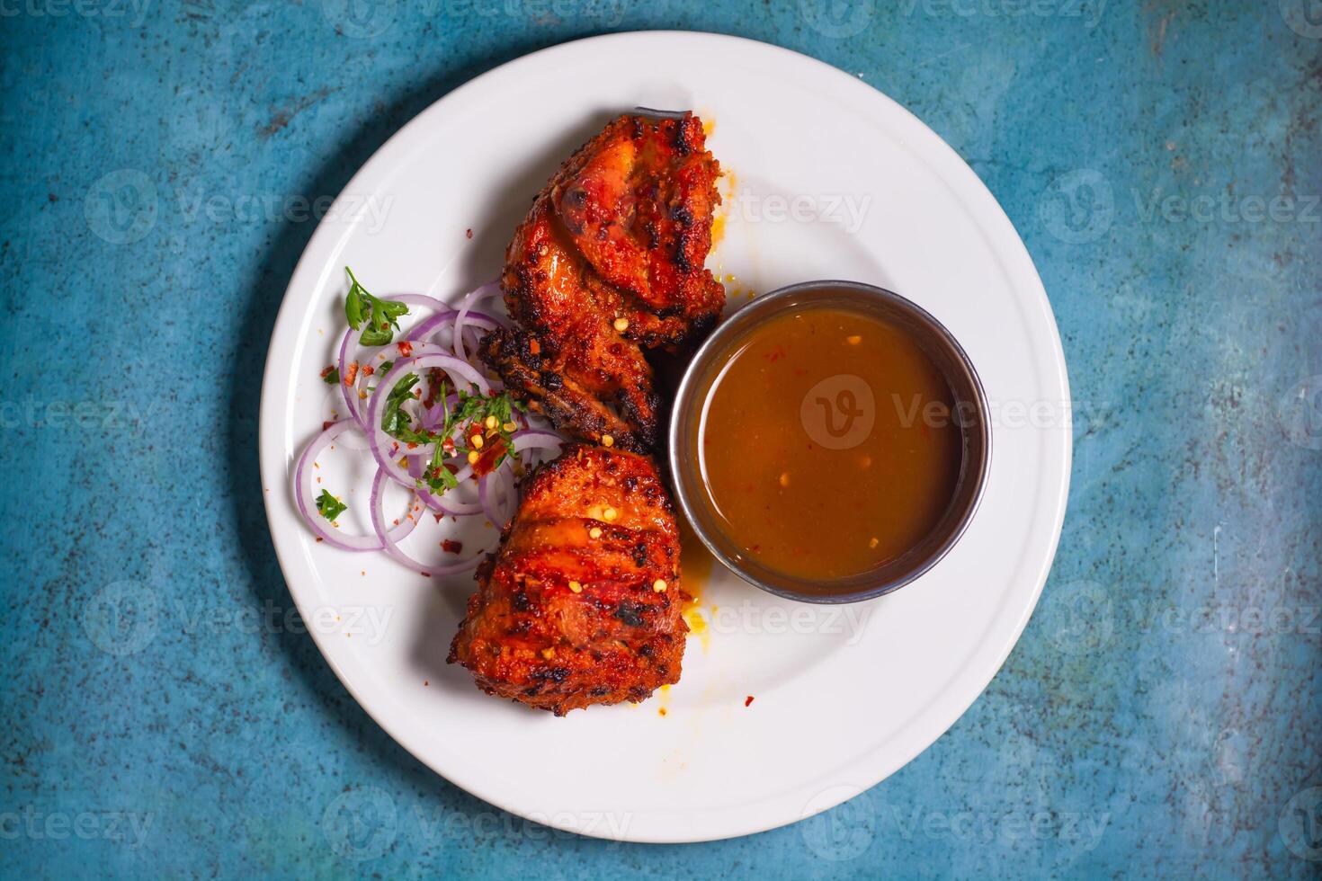 Chicken Bihari Tikka boti with chilli sauce and onion rings served in a plate top view of indian bbq fast food photo
