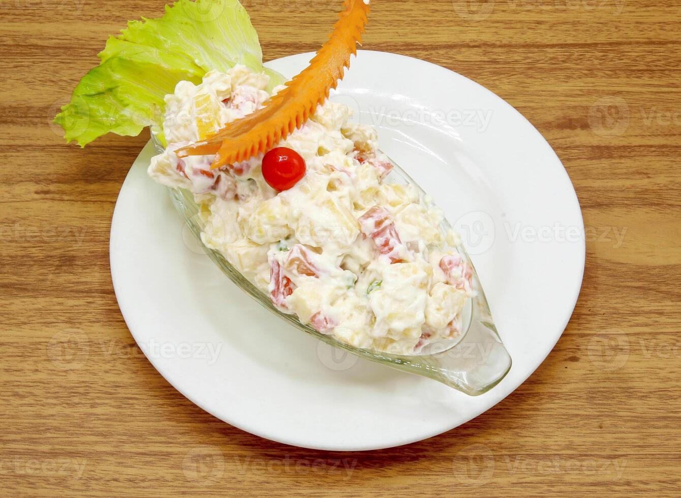 russian salad served in a dish isolated on grey background side view of indian, pakistani food photo