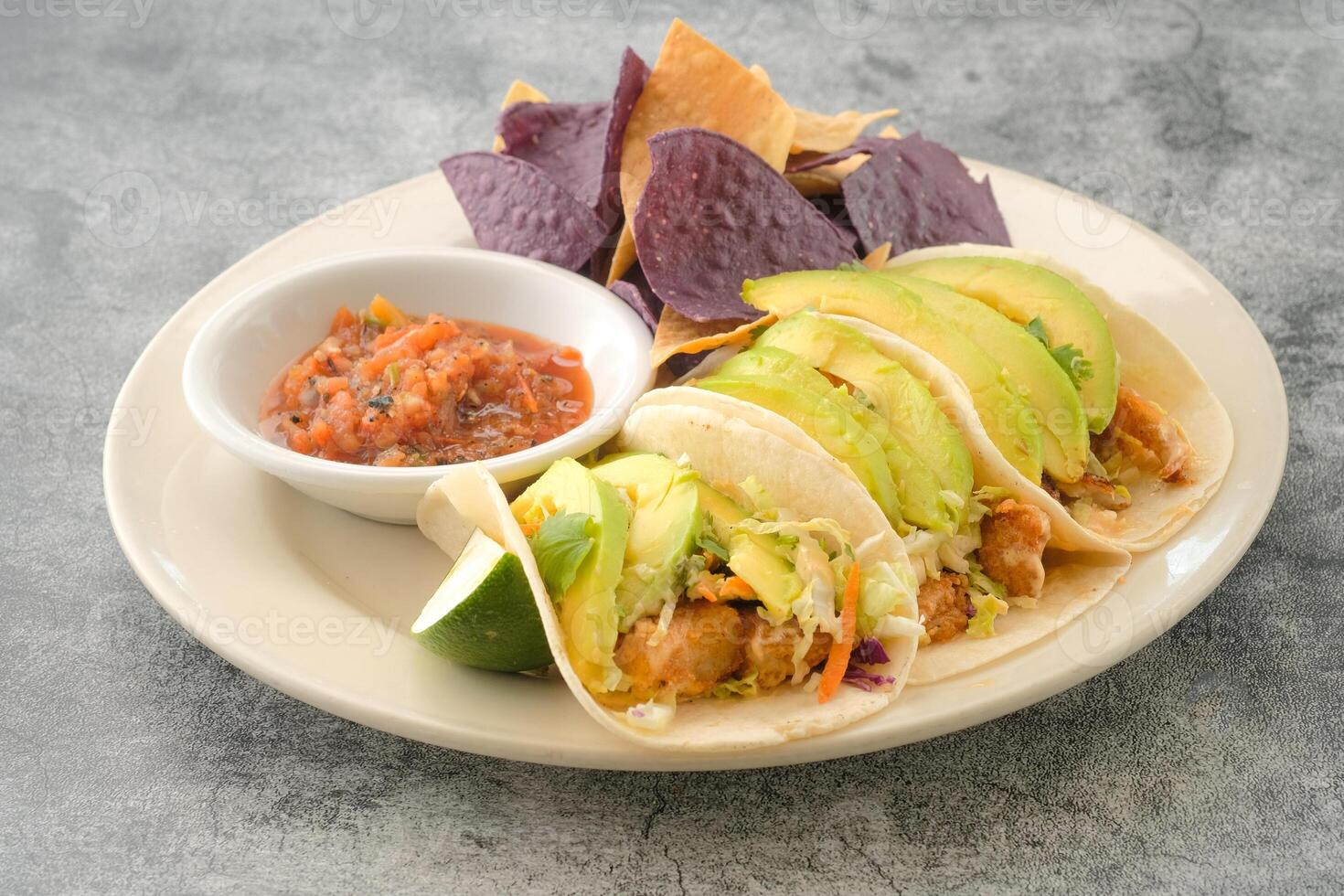 Specialty Fish Tacos with crackers served in a dish isolated on background side view of fastfood photo