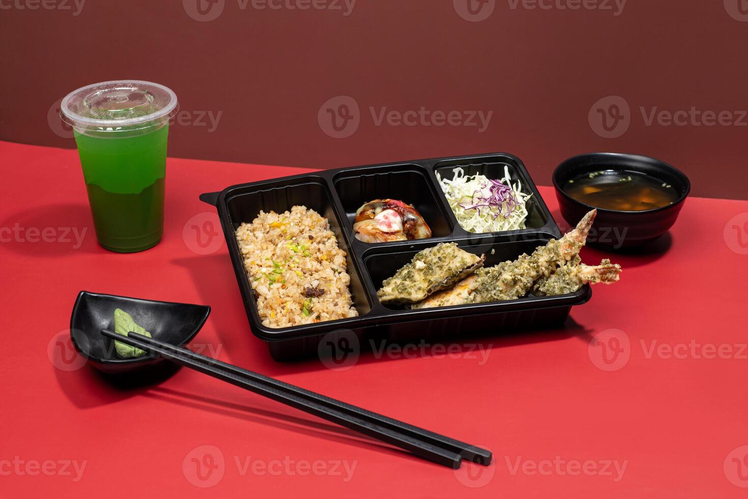 MIXED TEMPURA PREMIUM BENTO with mint margarita, sauce and chopsticks isolated on red background side view of japanese fast food photo