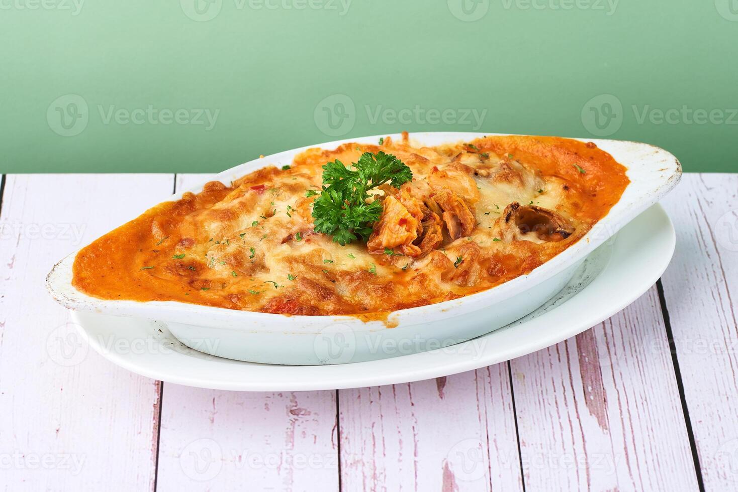 Mac and cheese, Italian style Baked Pasta Kimchi Cream in cheesy sauce in white plate on wooden table photo