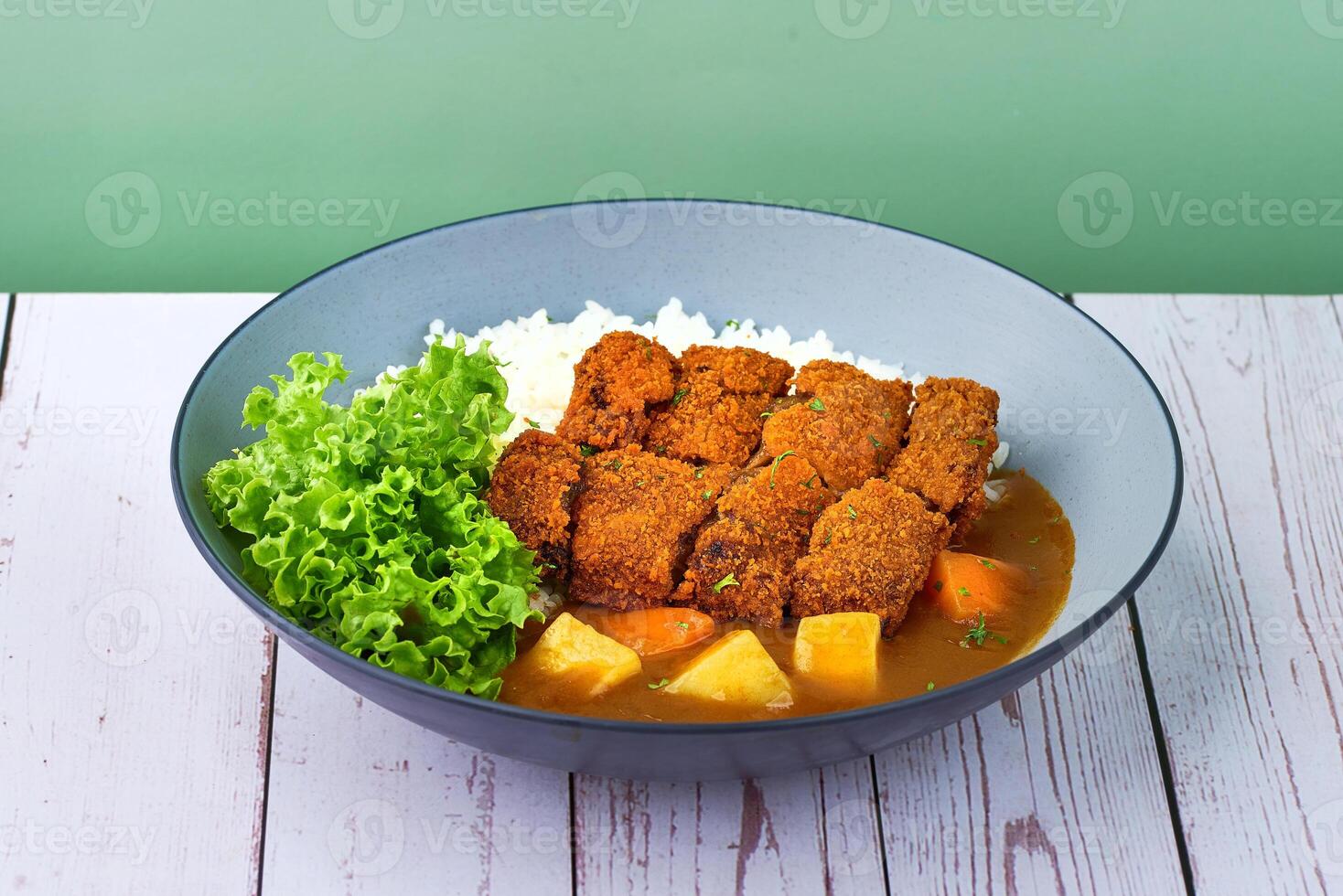 Traditional japanese food Rice Lion Mane Cheesy Patty Curry in a bowl on wooden table photo